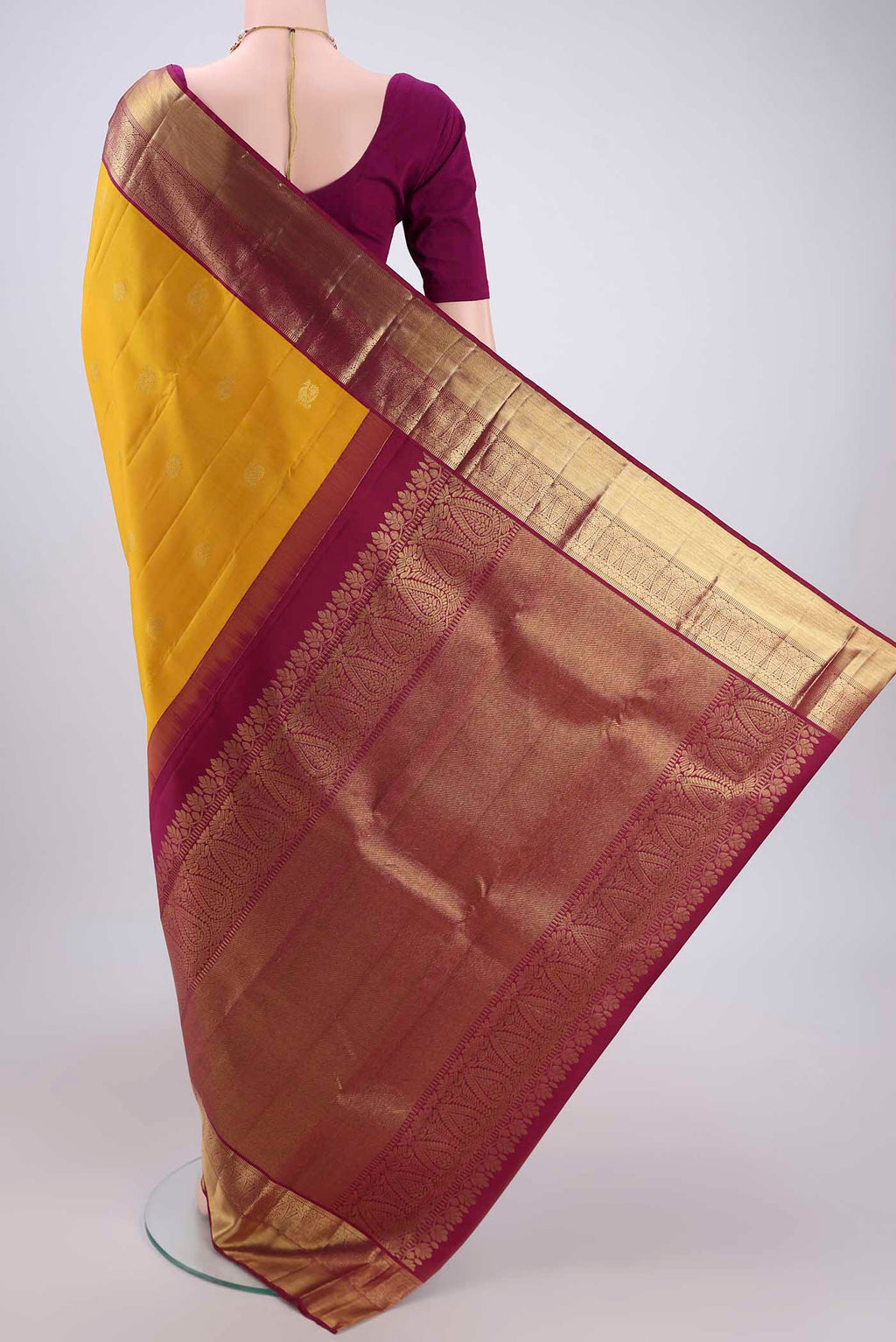 Flat view of Yellow Kanjivaram Silk Saree with Zari Butta on the body and Zari Border. 