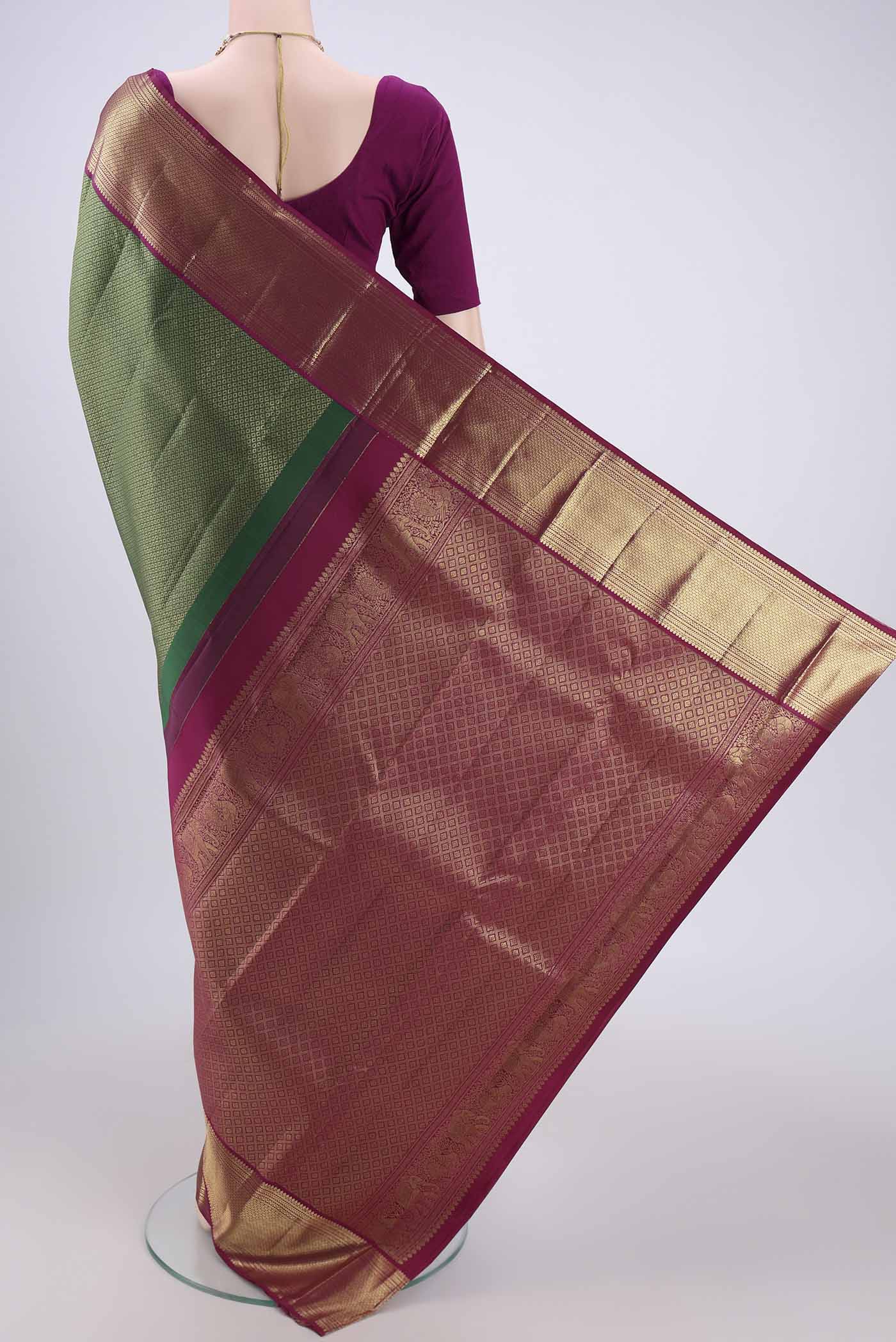 Flat view of Bottle Green Kanjivaram Silk Saree with Zari Brocade on the body and Zari Border. 