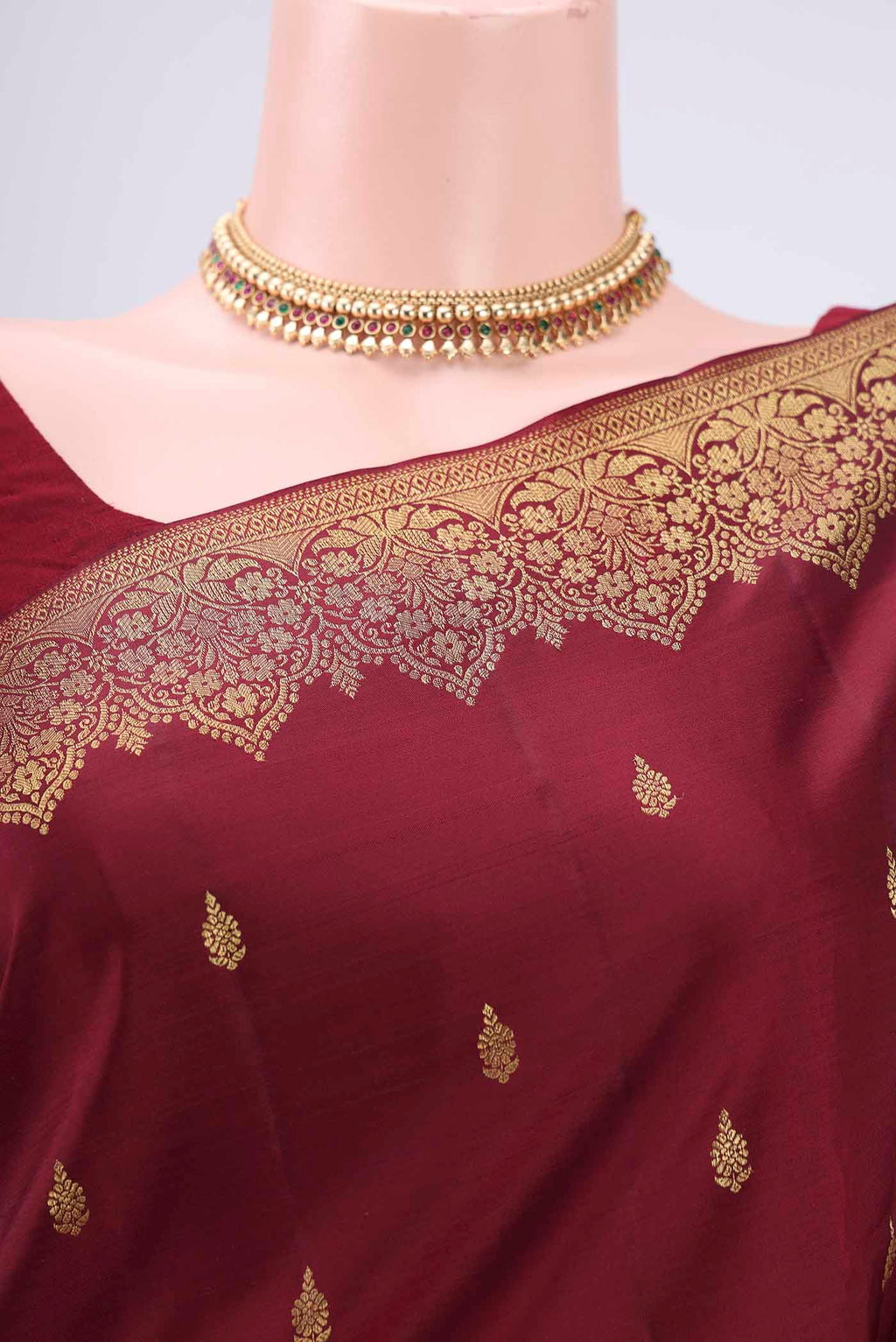 Border image of Maroon Kanjivaram Silk Saree with Zari Butta on the body and Zari Border. 