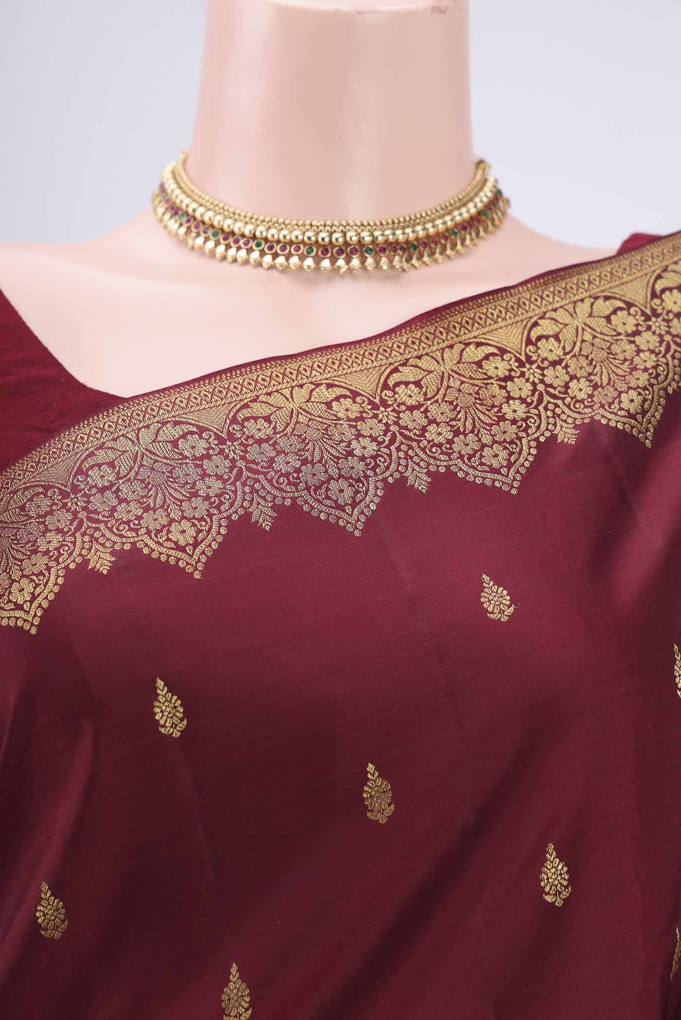 Border image of Maroon Kanjivaram Silk Saree with Zari Butta on the body and Zari Border. 