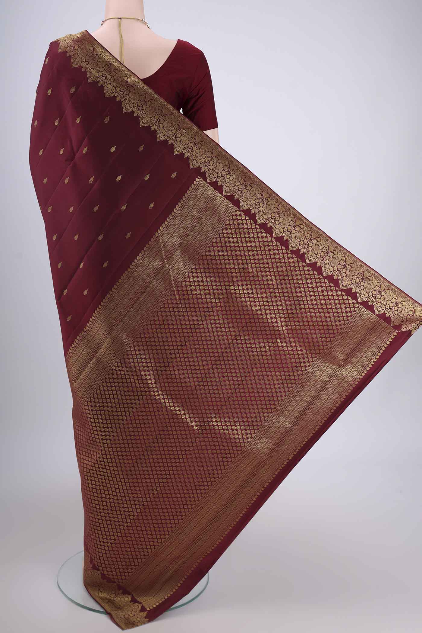 Flat view of Maroon Kanjivaram Silk Saree with Zari Butta on the body and Zari Border. 