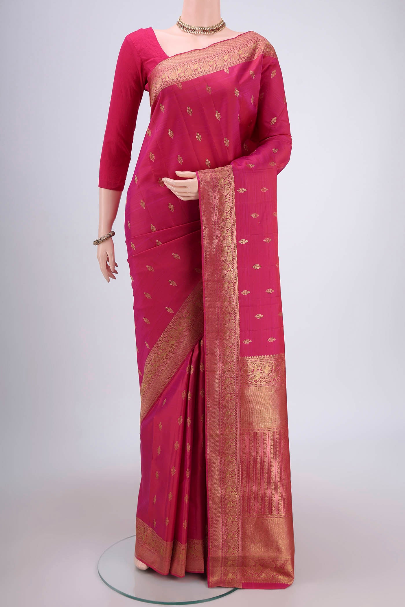 Pink Kanjivaram Silk Saree with Zari Butta on the body and Zari Border.  displayed on a mannequin