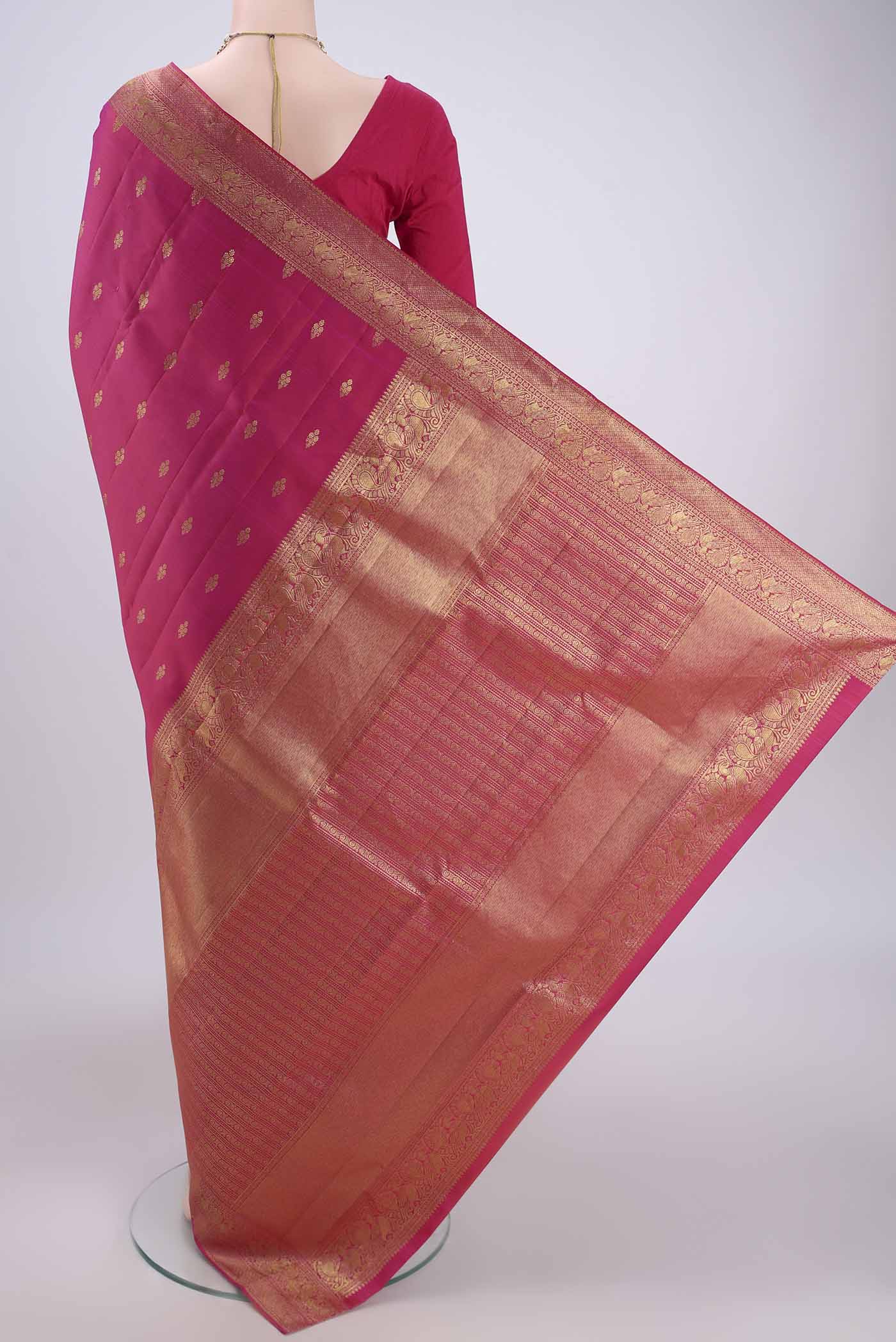 Flat view of Pink Kanjivaram Silk Saree with Zari Butta on the body and Zari Border. 