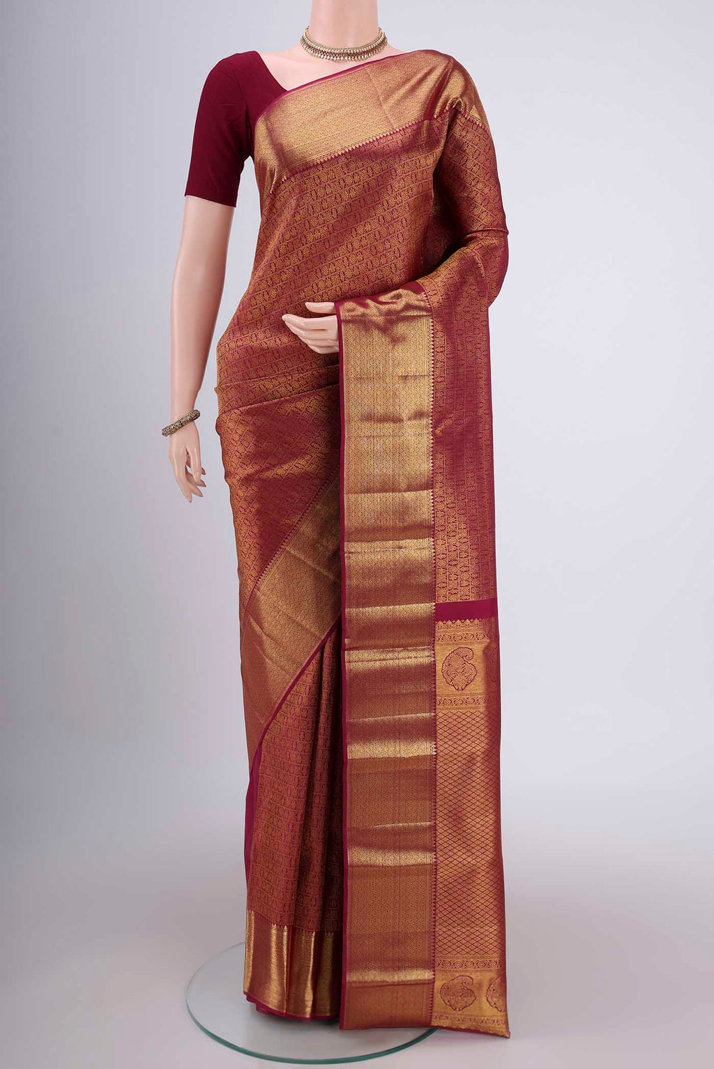 Magenta Kanjivaram Silk Saree with Zari Brocade on the body and Zari Border.  displayed on a mannequin