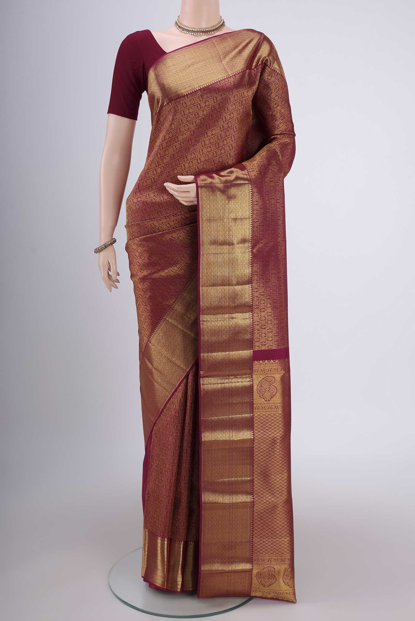 Magenta Kanjivaram Silk Saree with Zari Brocade on the body and Zari Border.  displayed on a mannequin