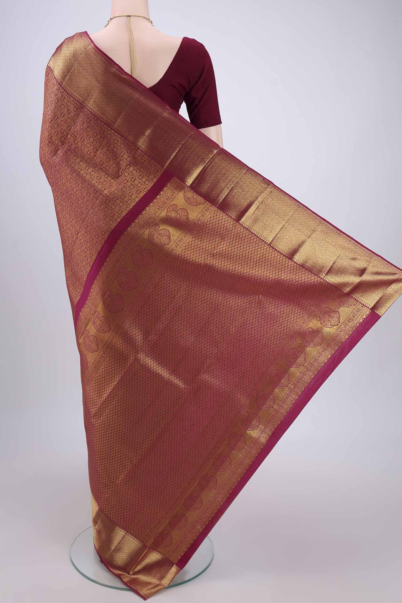 Flat view of Magenta Kanjivaram Silk Saree with Zari Brocade on the body and Zari Border. 