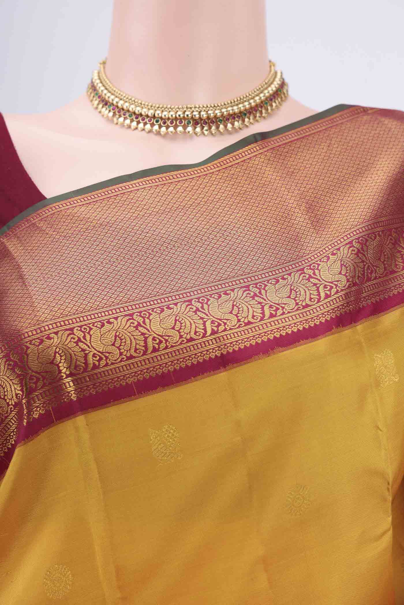 Border image of Mustard Kanjivaram Silk Saree with Zari Butta on the body and Zari Border. 