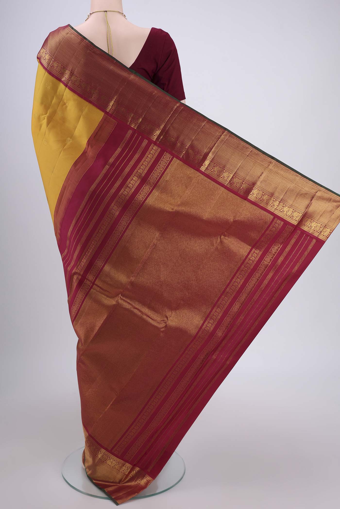 Flat view of Mustard Kanjivaram Silk Saree with Zari Butta on the body and Zari Border. 