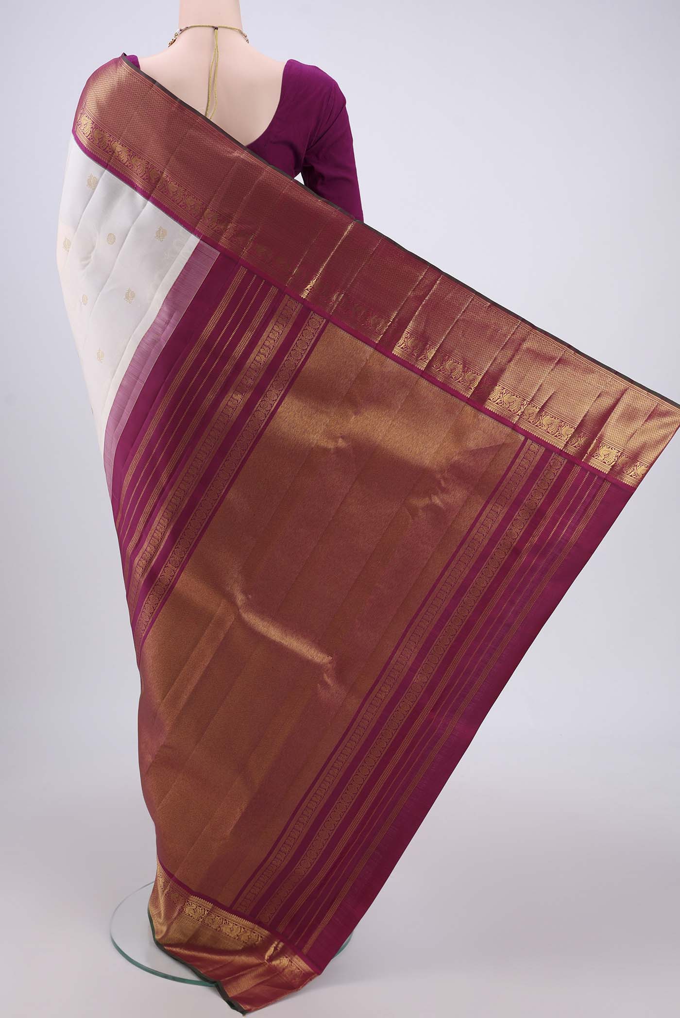 Flat view of Off White Kanjivaram Silk Saree with Zari Butta on the body and Zari Border. 