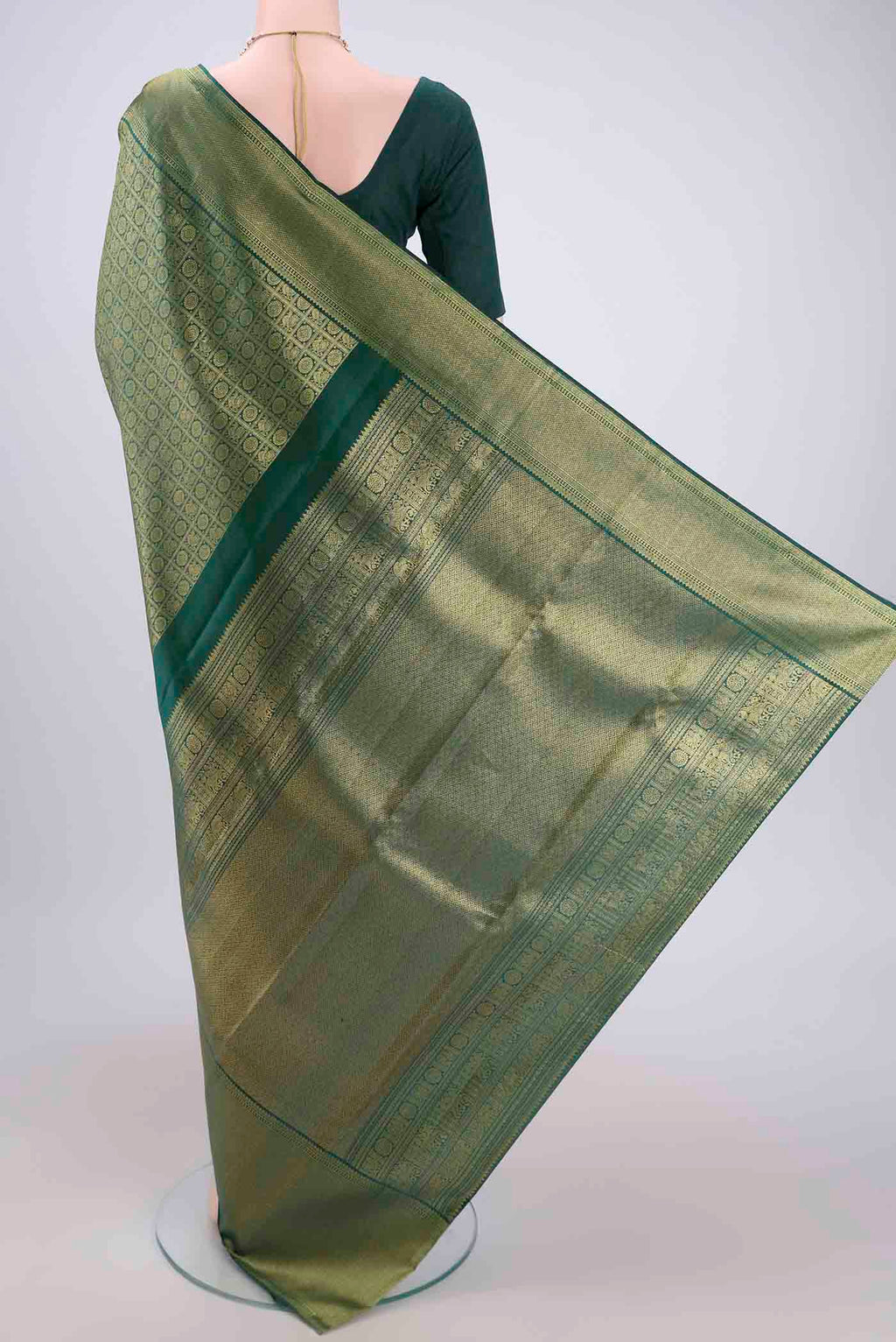 Flat view of Bottle Green Kanjivaram Silk Saree with Zari Brocade on the body and Zari Border. 