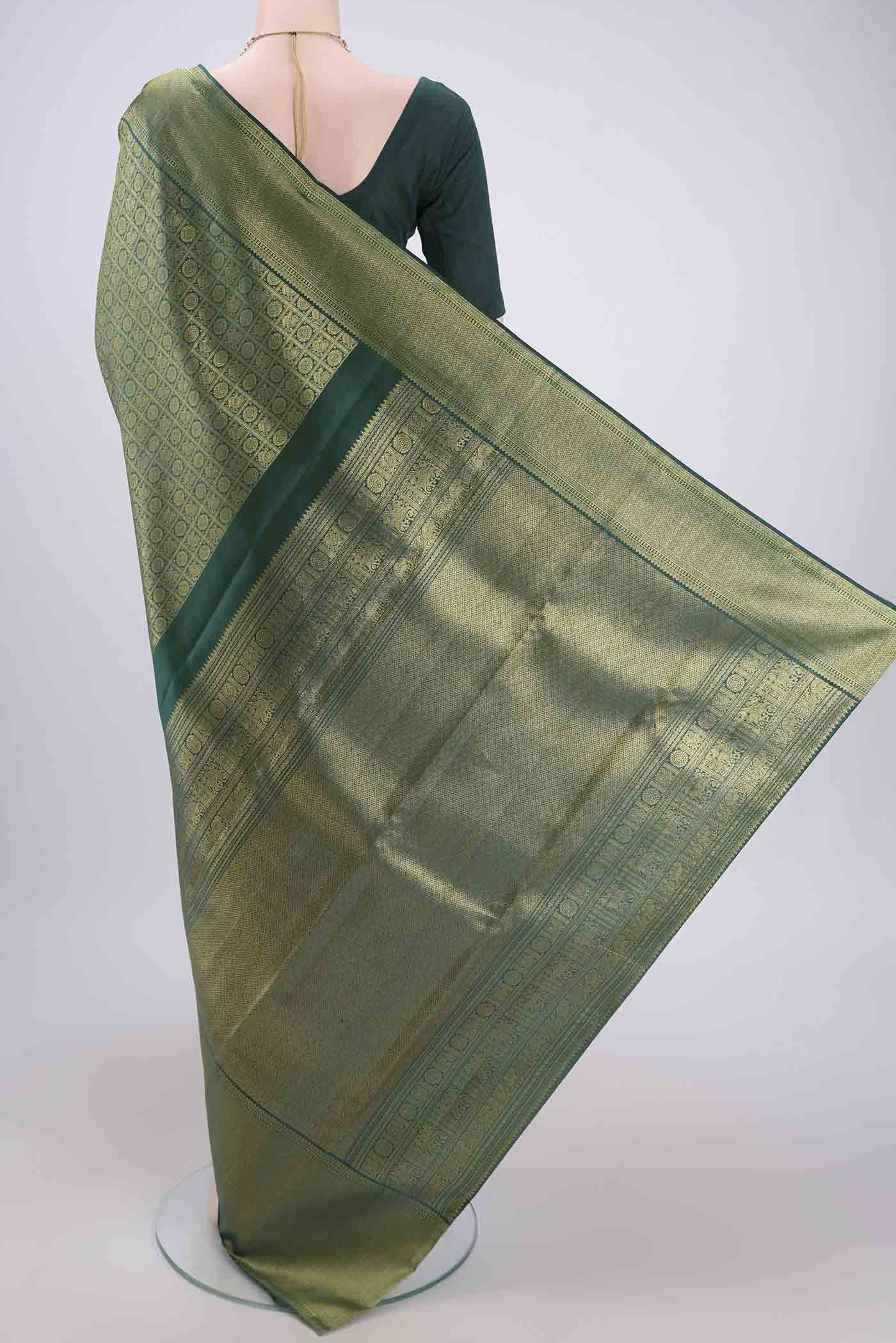 Flat view of Bottle Green Kanjivaram Silk Saree with Zari Brocade on the body and Zari Border. 