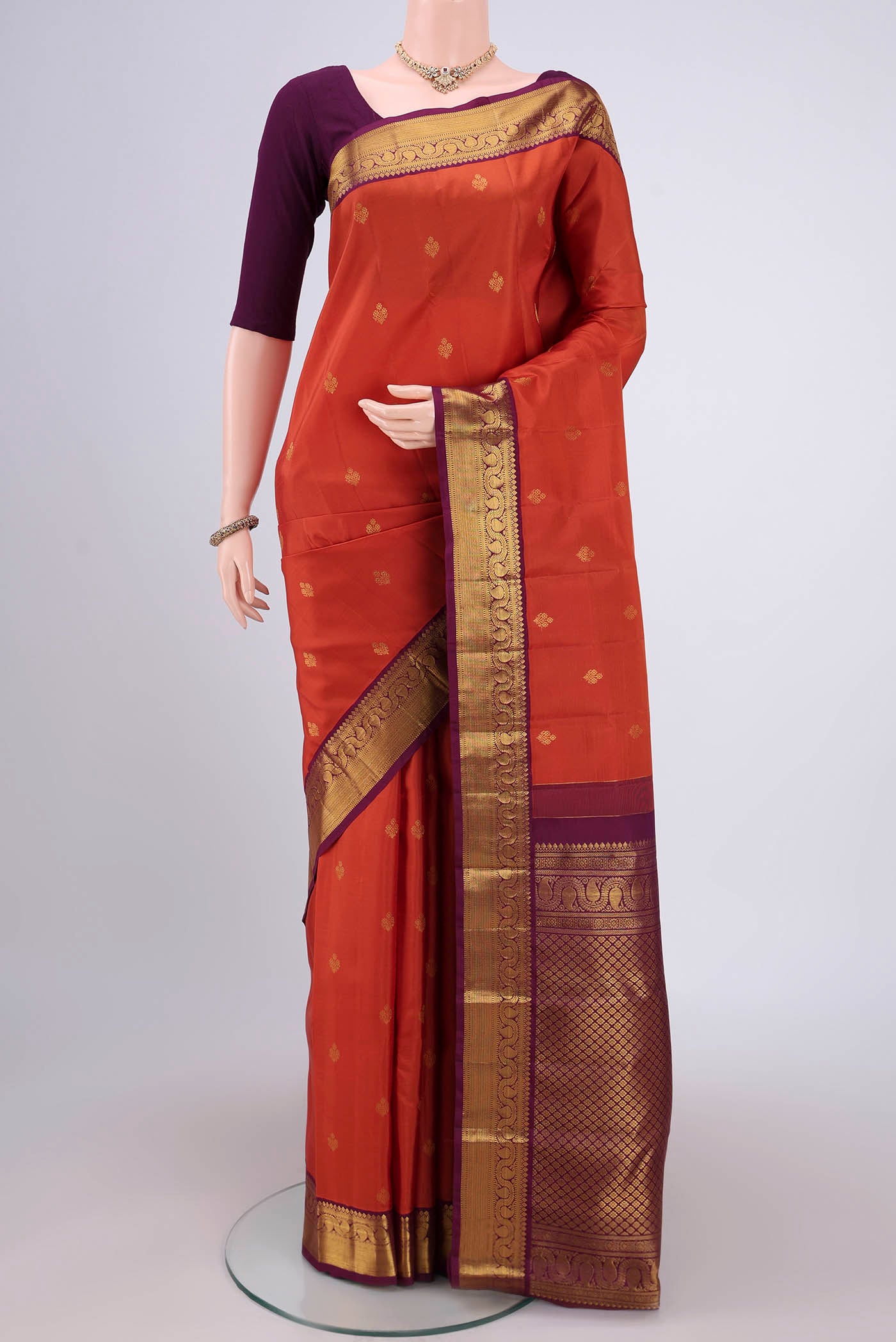 Orange Dual Tone Kanjivaram Silk Saree with Plain Body and Attached Border.  displayed on a mannequin