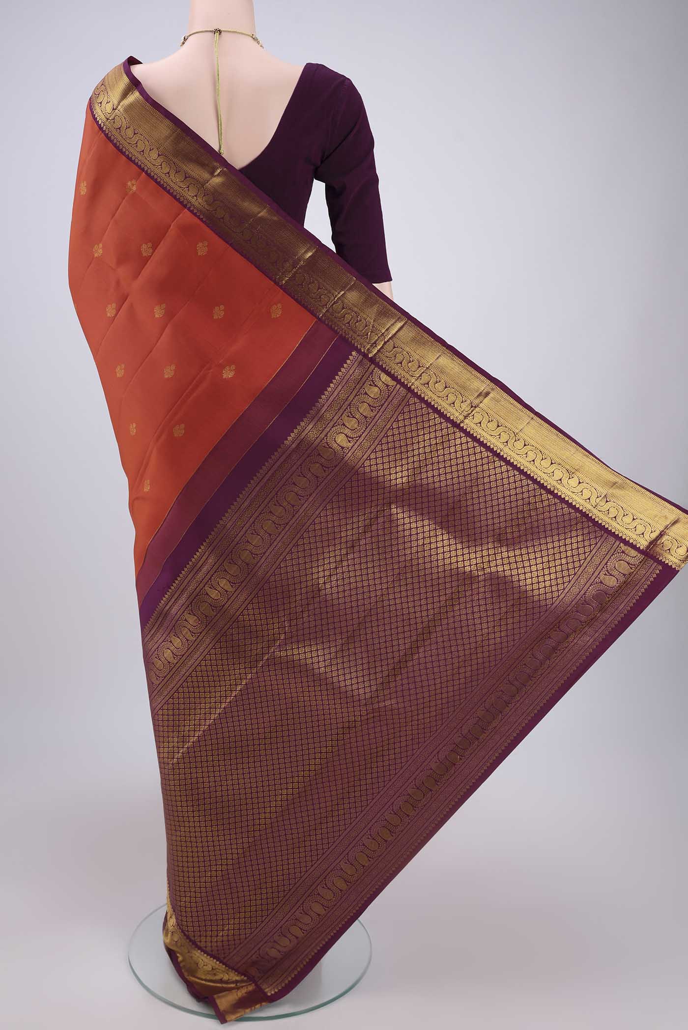 Flat view of Orange Dual Tone Kanjivaram Silk Saree with Plain Body and Attached Border. 
