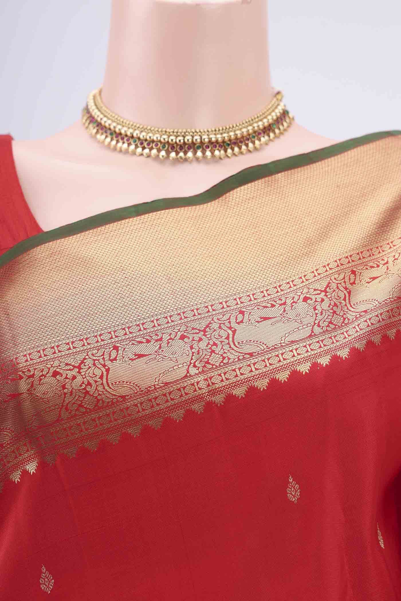 Border image of Red Kanchipuram Silk Saree with Zari And Thread Butta on the body and Zari Border. 