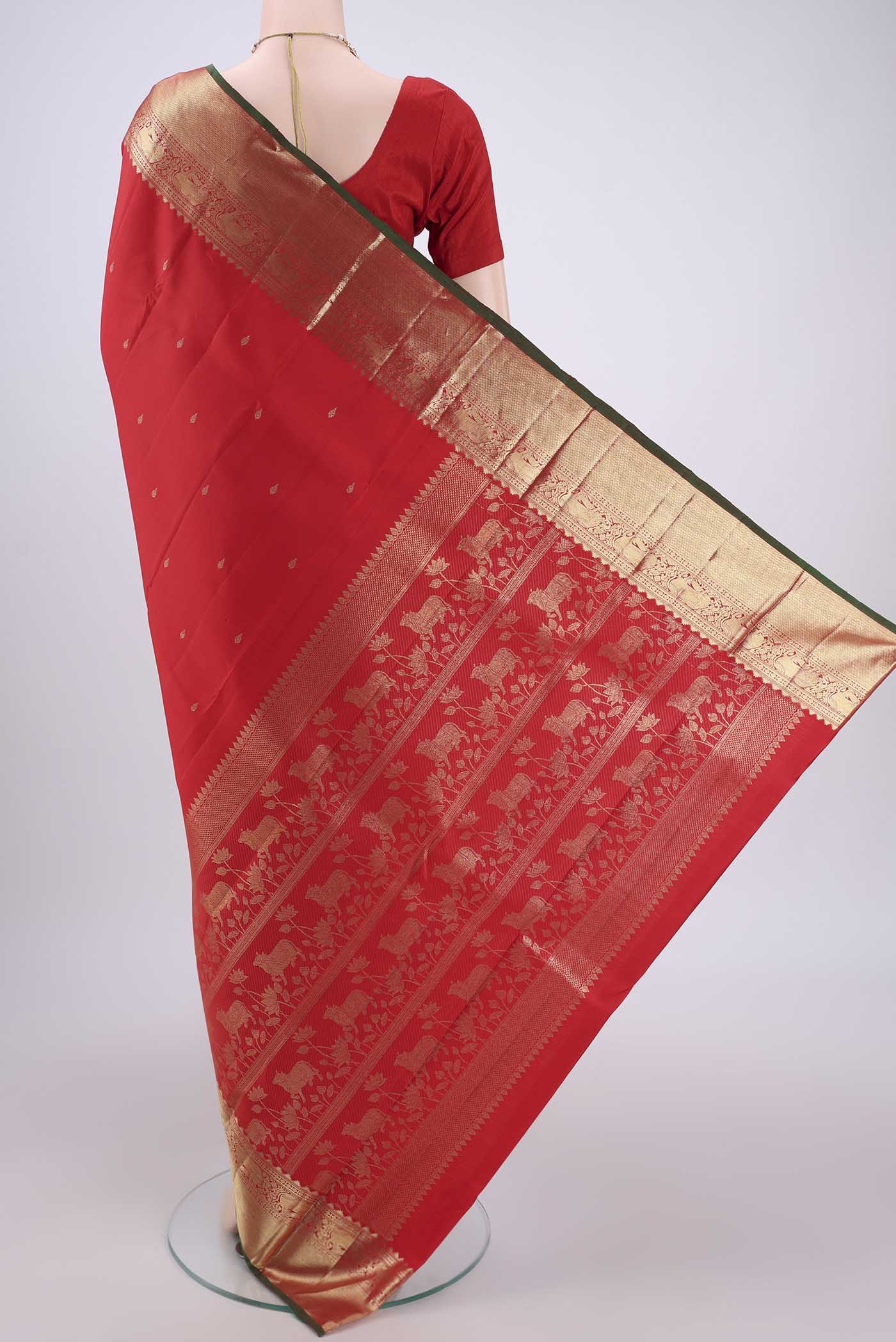 Flat view of Red Kanchipuram Silk Saree with Zari And Thread Butta on the body and Zari Border. 