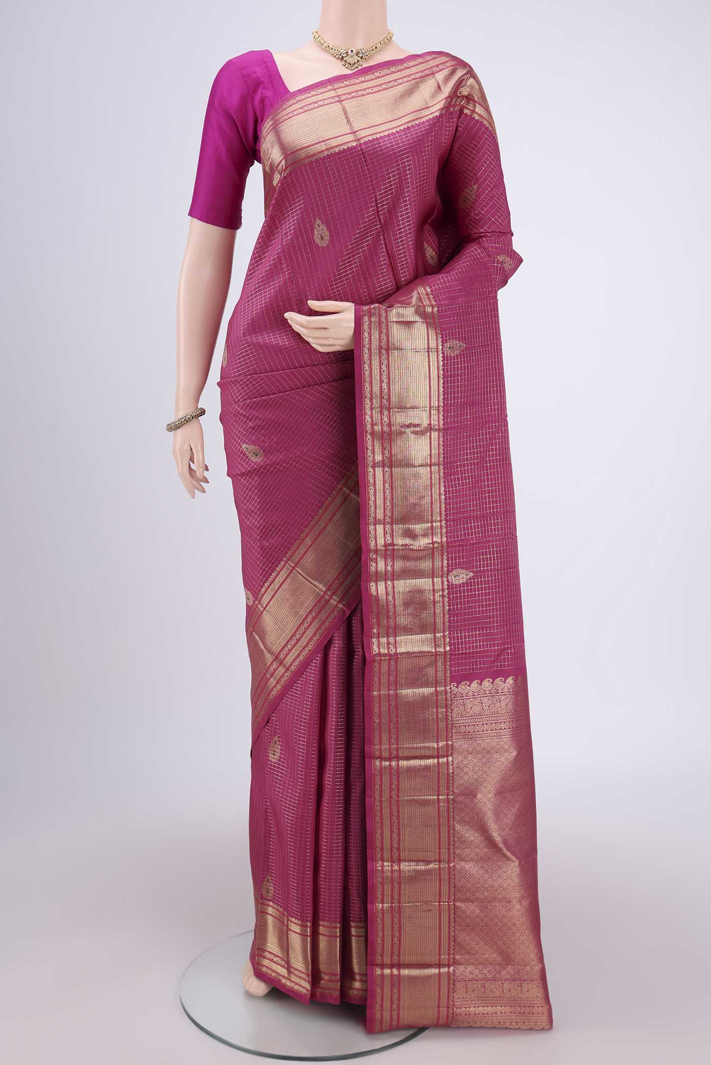 Pink Kanjivaram Silk Saree with Checked design on the body and Zari And Thread Border.  displayed on a mannequin