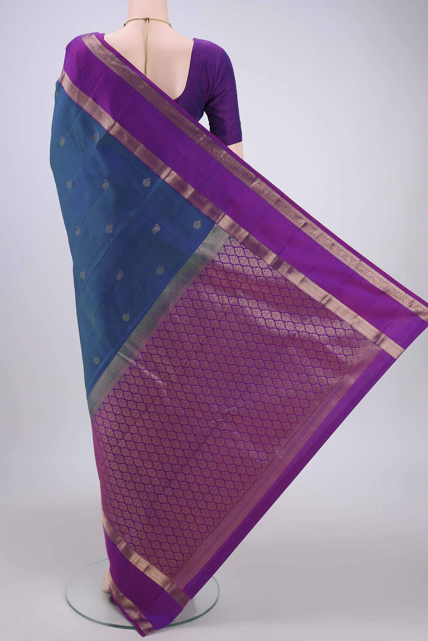 Flat view of Peacock Blue Kanchipuram Silk Saree with Zari Butta on the body and Zari Border. 