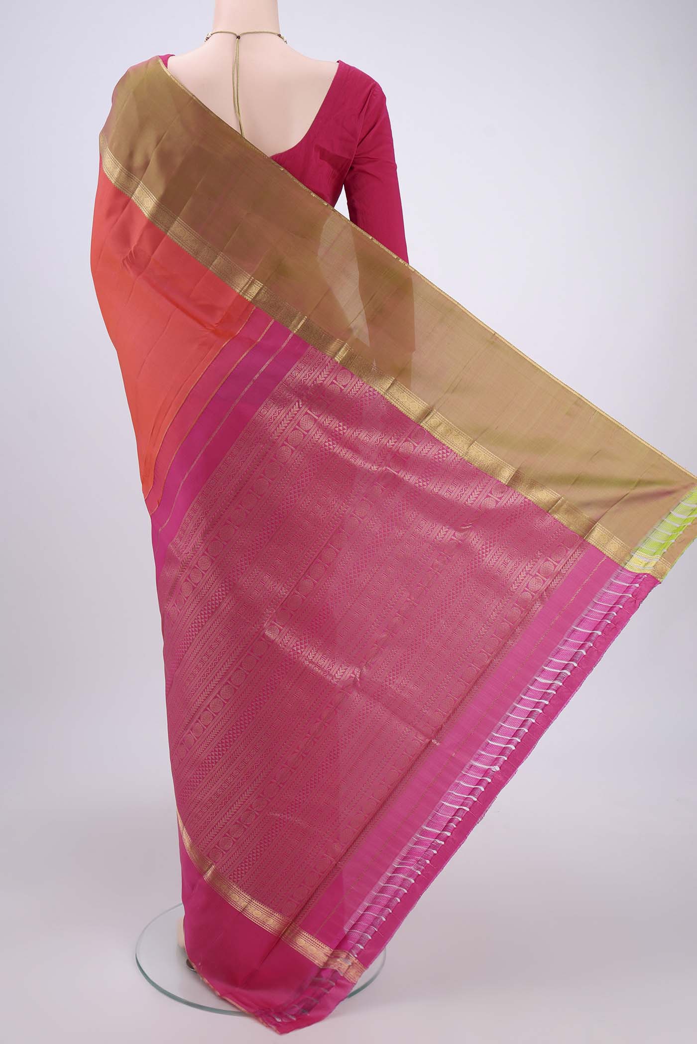 Flat view of Orange Kanchipuram Silk Saree with Zari Butta on the body and Ganga Jamuna Border. 