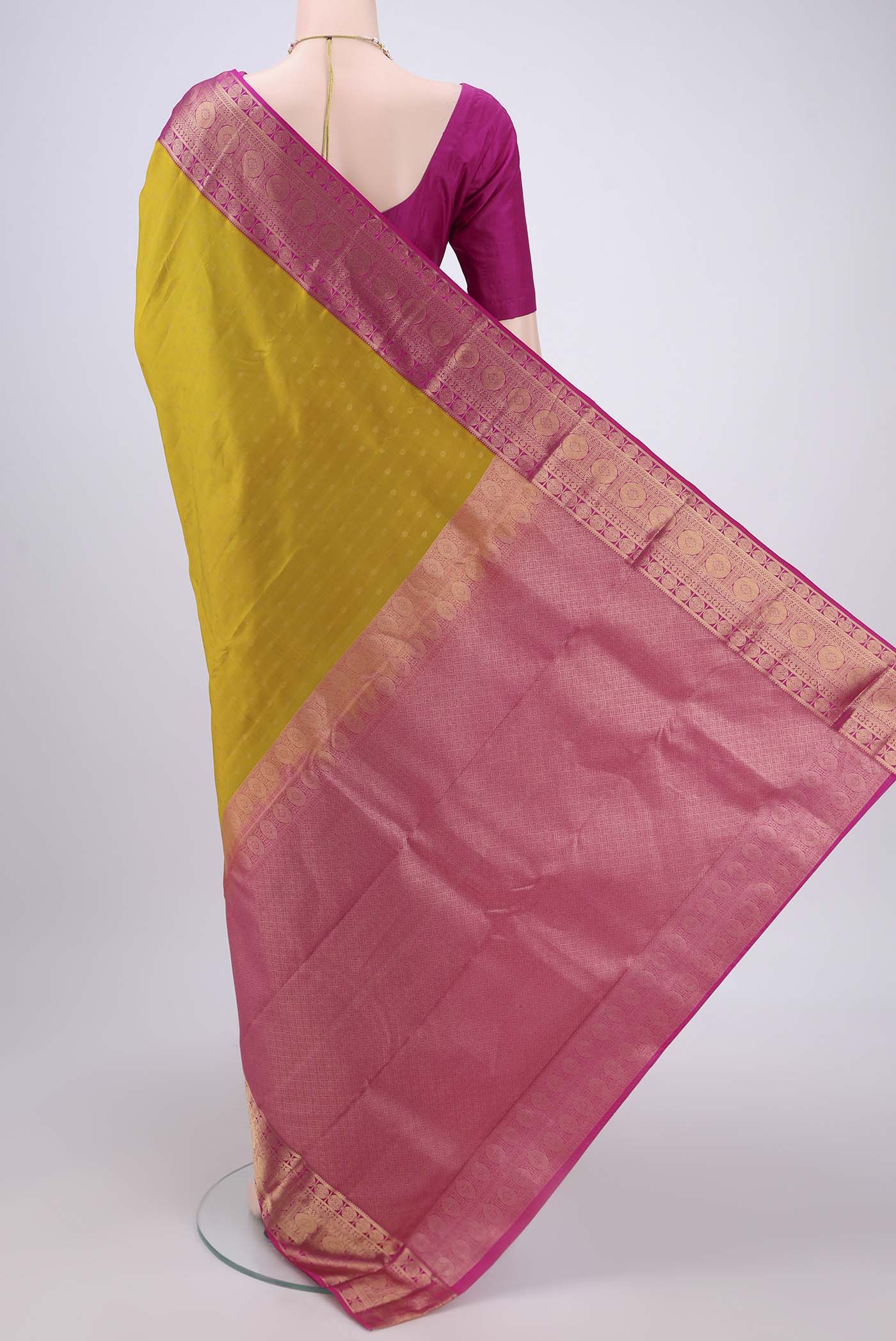Flat view of Acid Green Kanchipuram Silk Saree with Zari Butta on the body and Zari Border. 