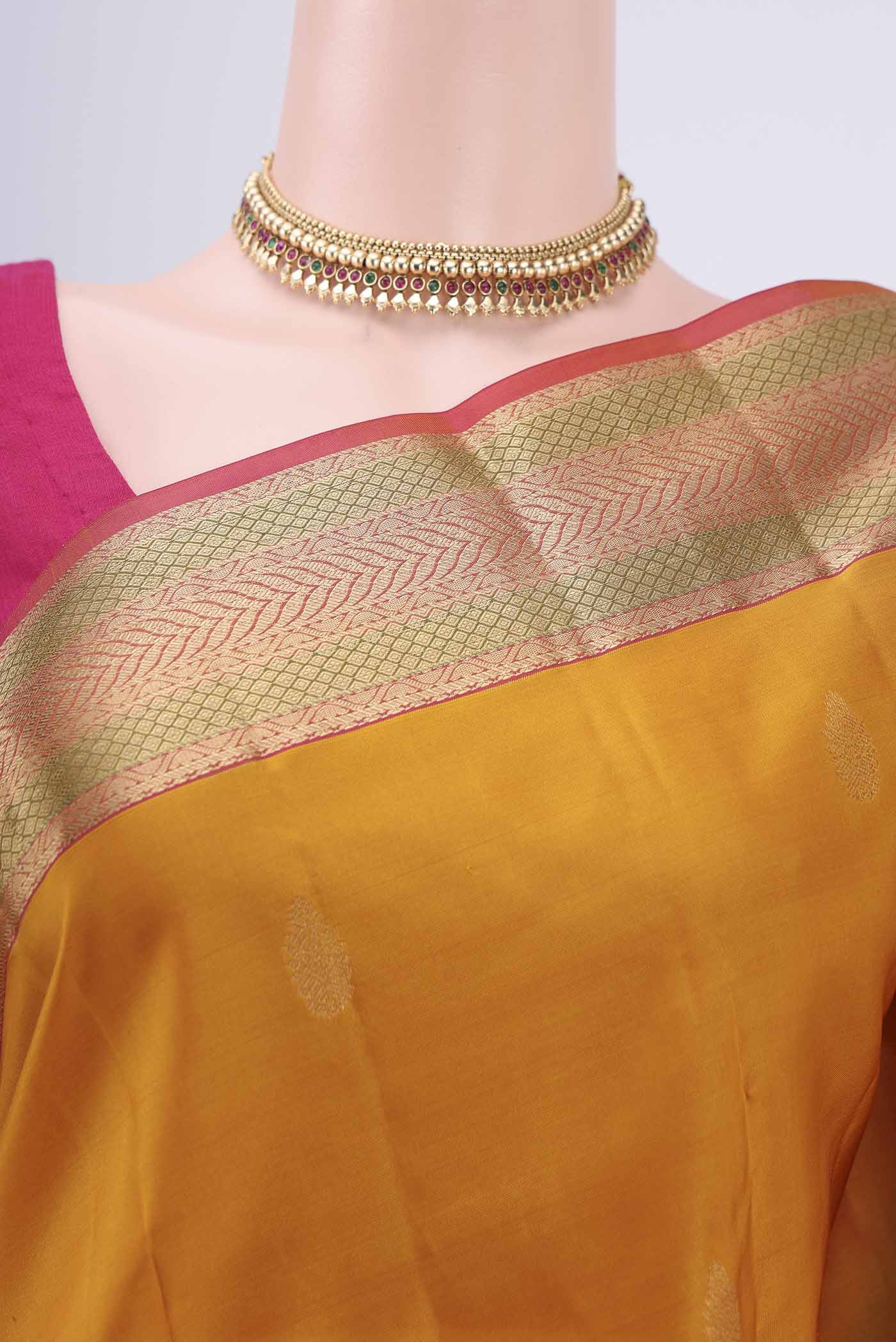 Border image of Mustard Kanchipuram Silk Saree with Zari Butta on the body and Zari Border. 