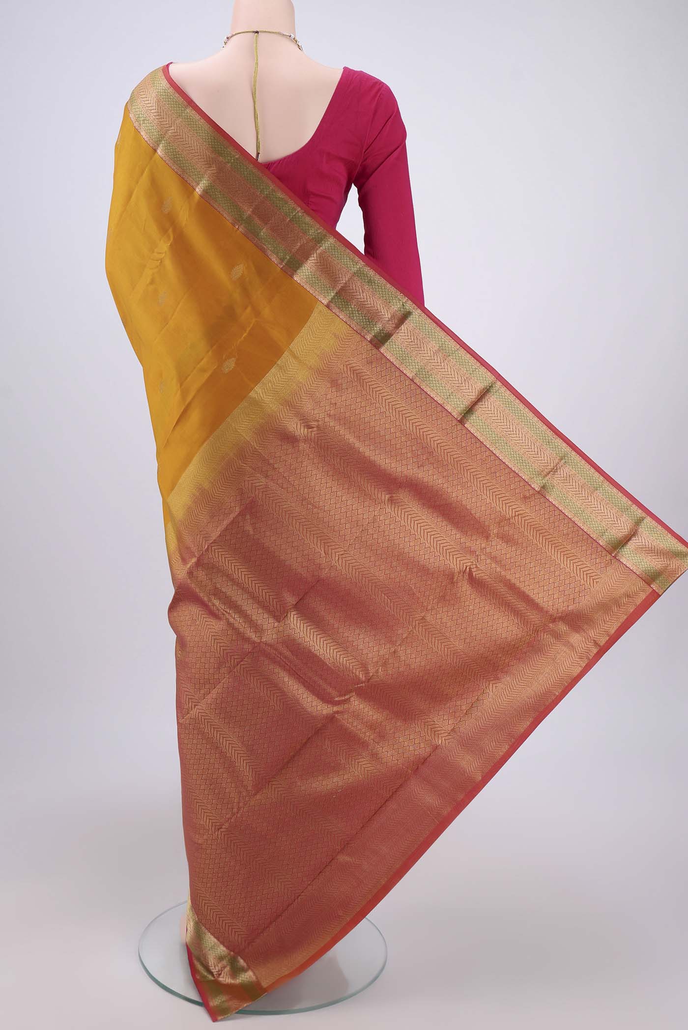 Flat view of Mustard Kanchipuram Silk Saree with Zari Butta on the body and Zari Border. 
