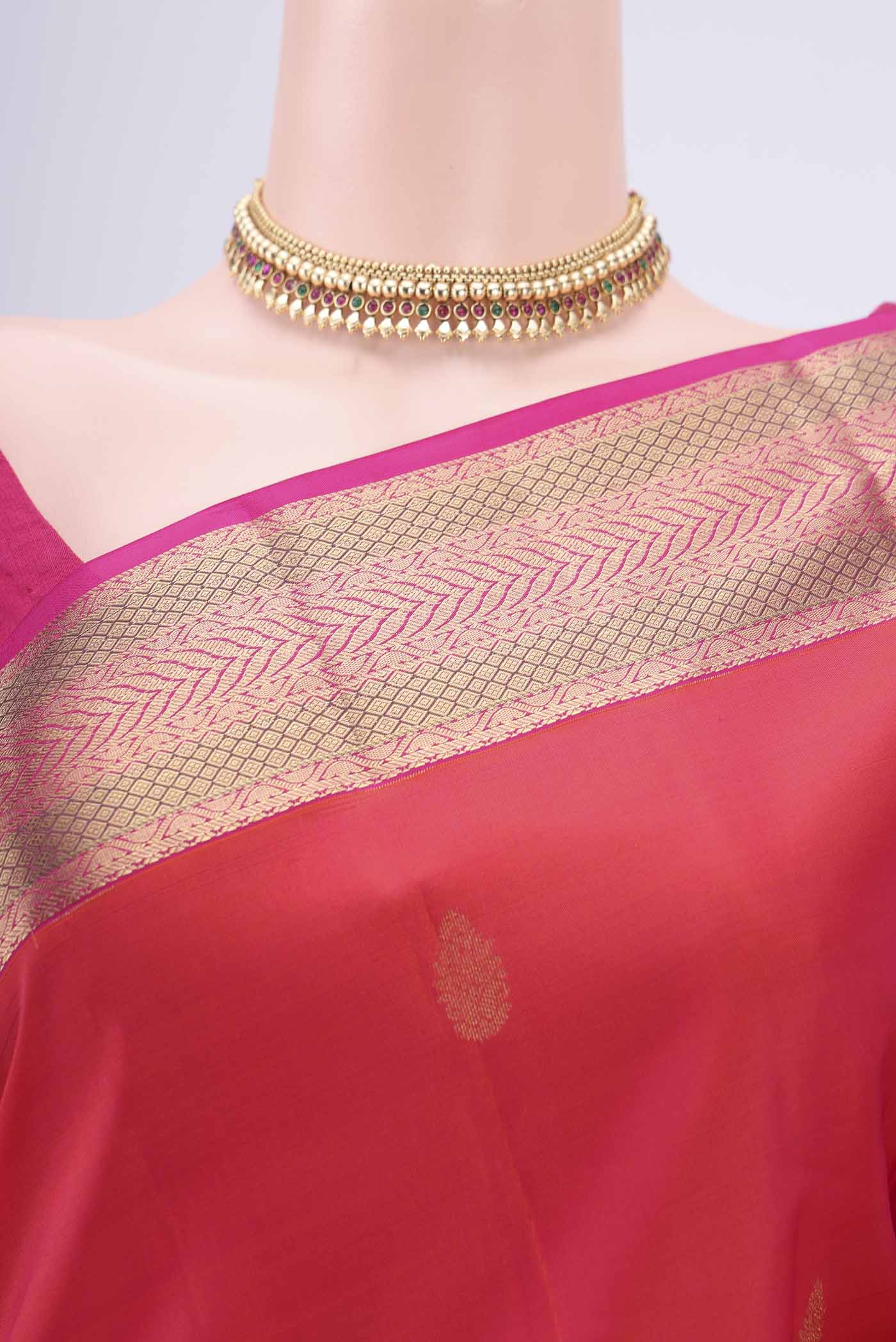 Border image of Orange Kanchipuram Silk Saree with Zari Butta on the body and Zari Border. 