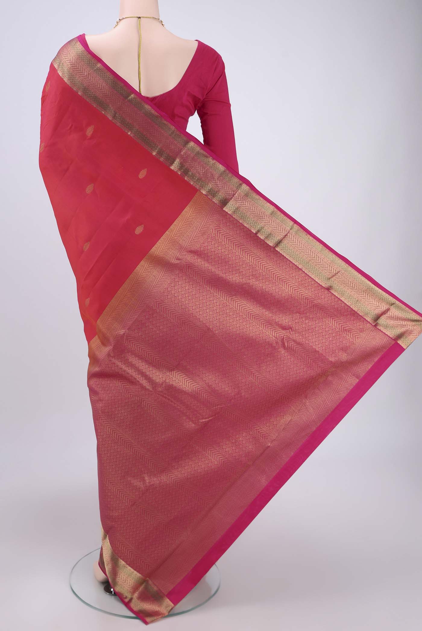 Flat view of Orange Kanchipuram Silk Saree with Zari Butta on the body and Zari Border. 