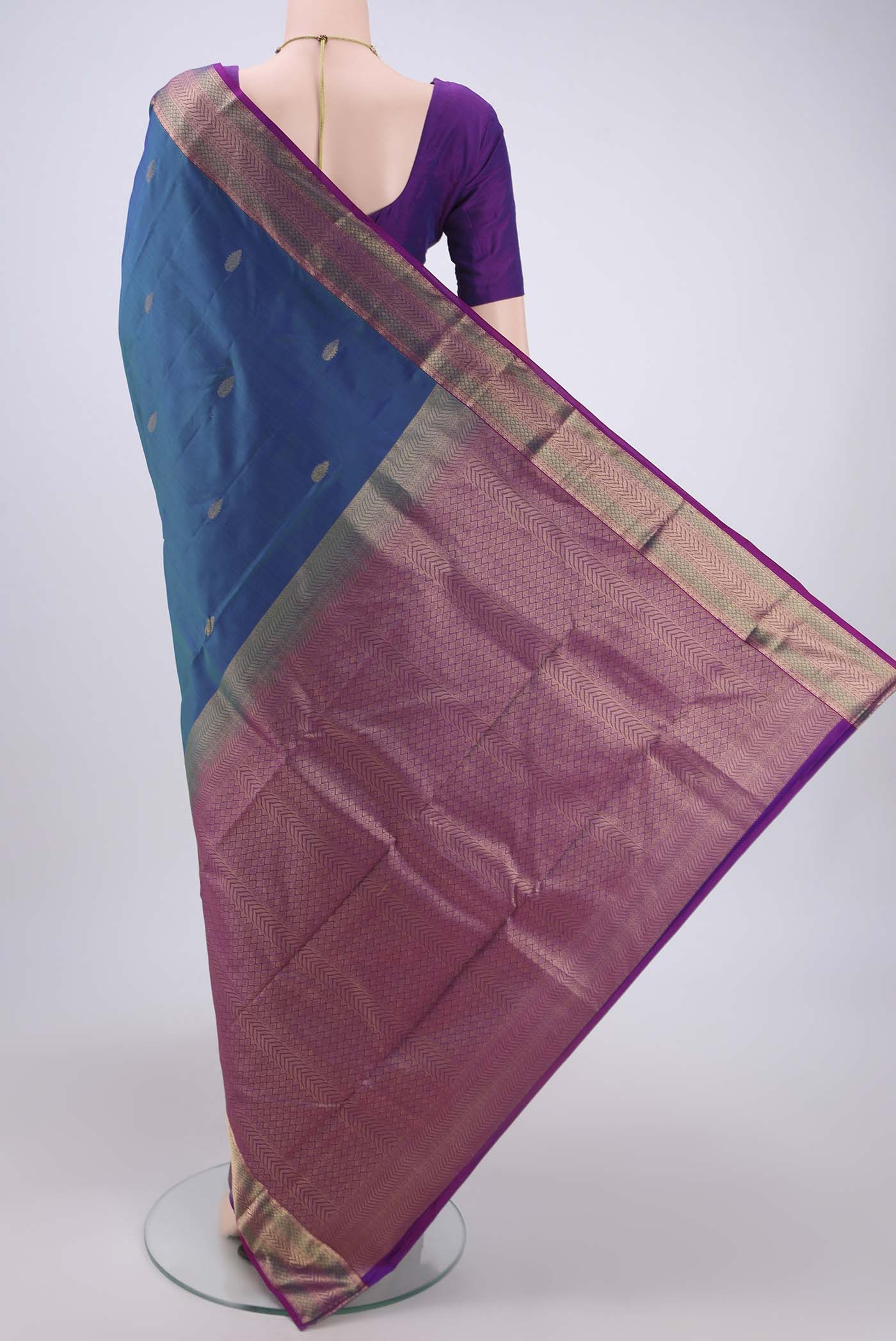 Flat view of Peacock Blue Kanchipuram Silk Saree with Zari Butta on the body and Zari Border. 