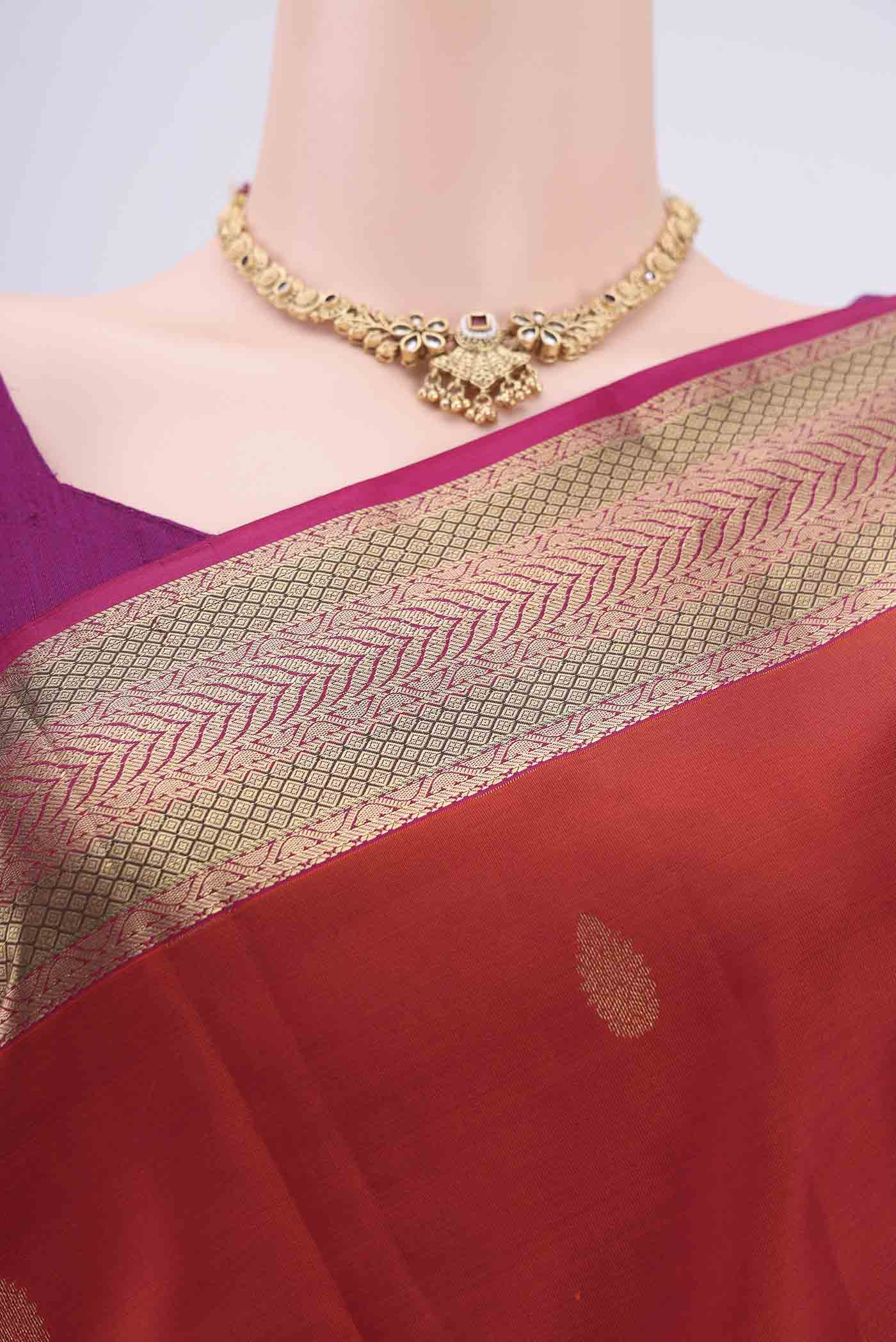 Border image of Rust Kanchipuram Silk Saree with Zari Butta on the body and Zari Border. 