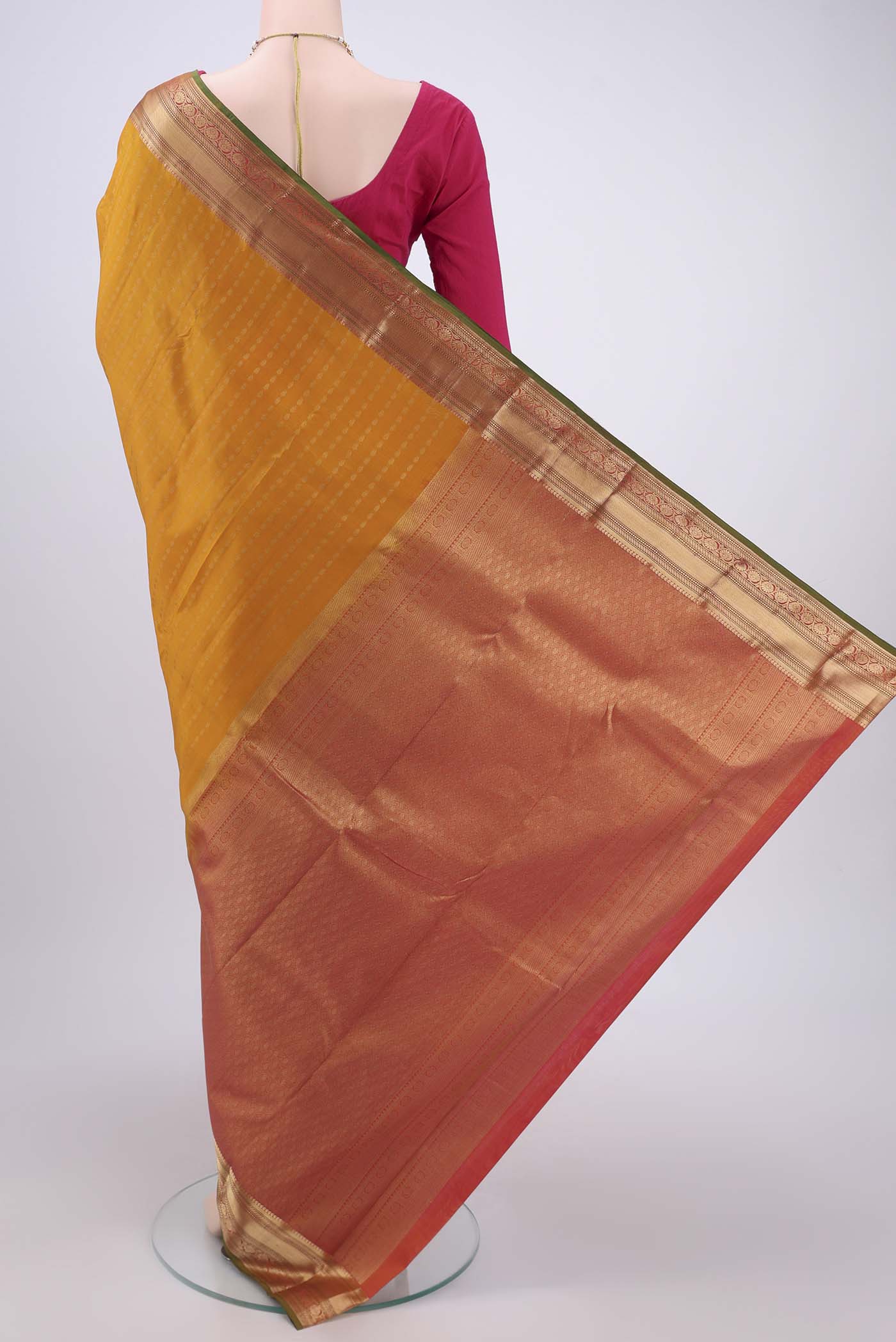 Flat view of Yellow Kanchipuram Silk Saree with Zari Butta on the body and Zari Border. 