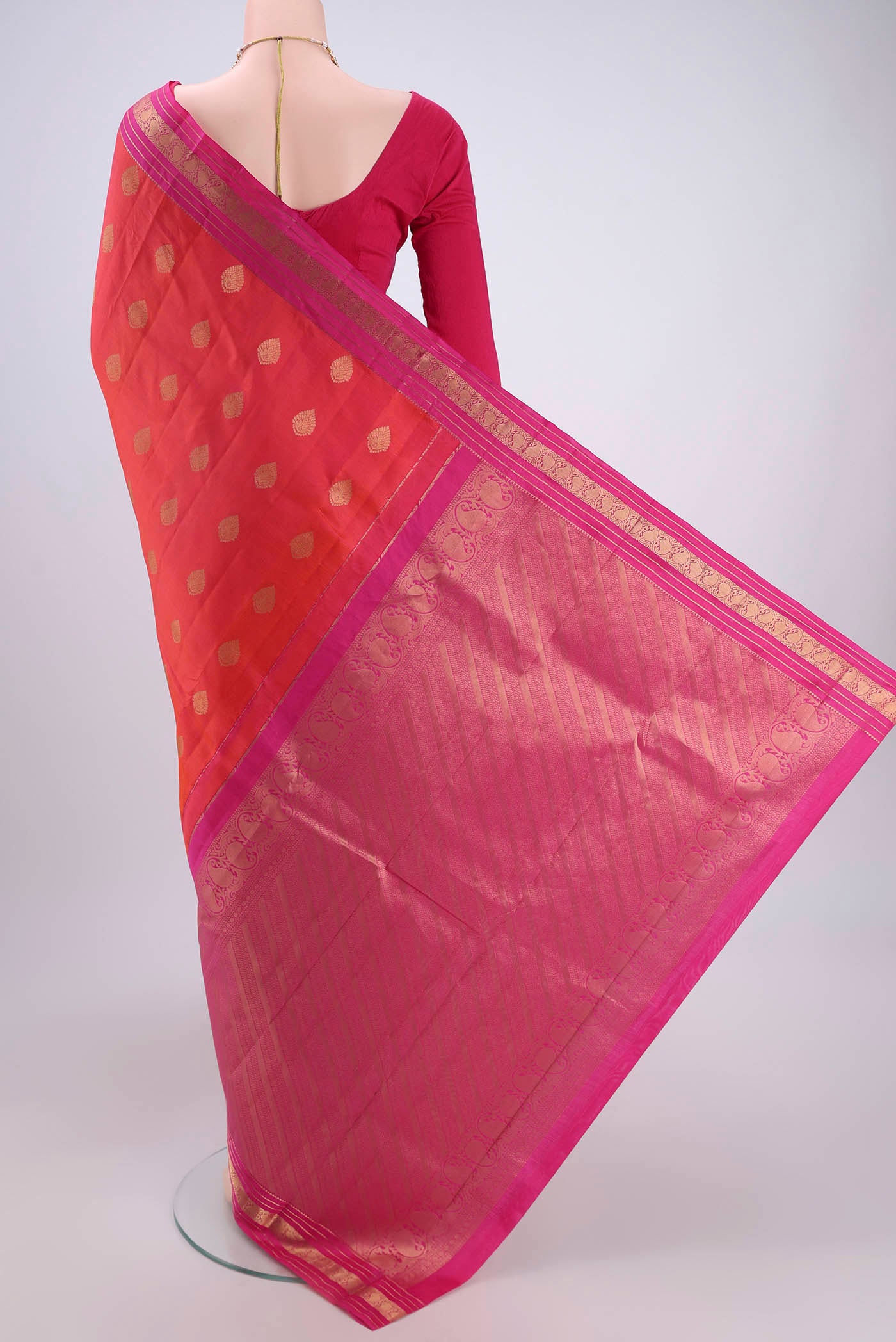 Flat view of Orange Kanchipuram Silk Saree with Zari Butta on the body and Zari Border. 