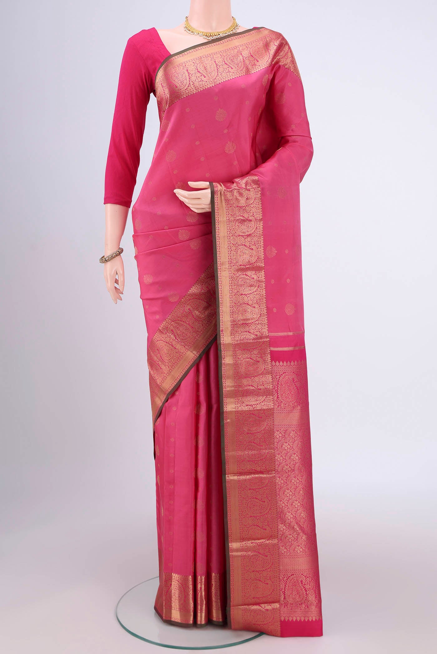 Pink Kanjivaram Silk Saree with Zari Butta on the body and Zari Border.  displayed on a mannequin