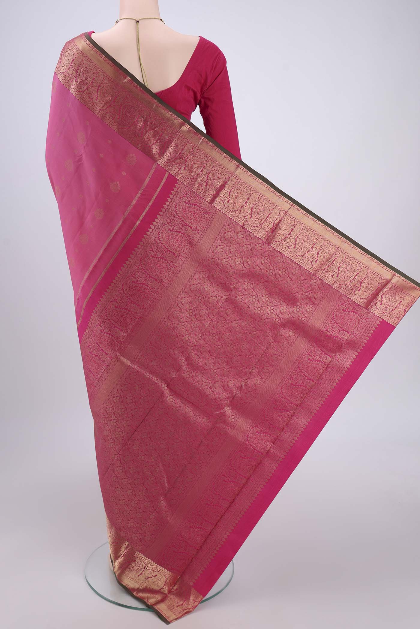 Flat view of Pink Kanjivaram Silk Saree with Zari Butta on the body and Zari Border. 