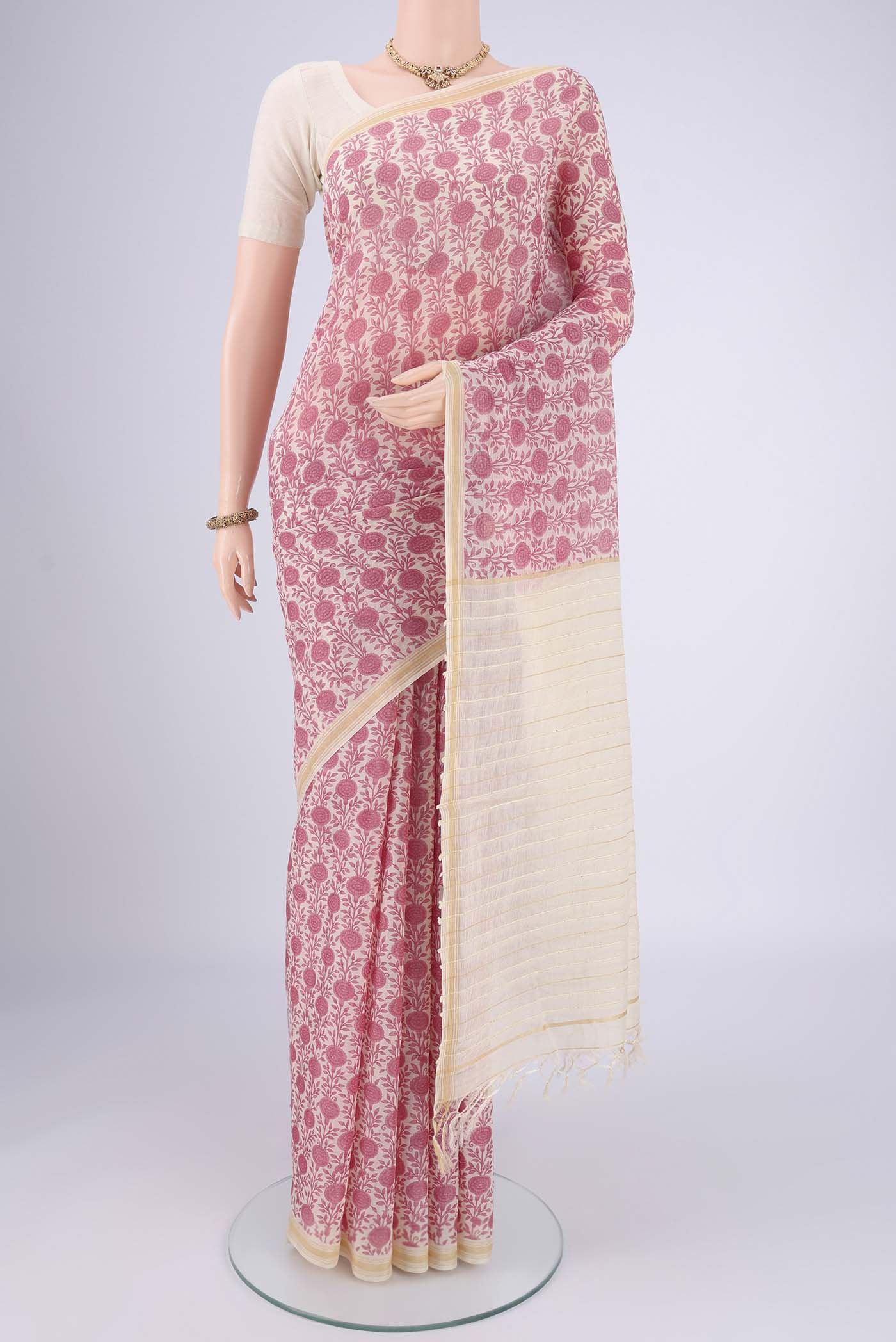 Off White Tussar Silk Saree with Floral Print on the body and Thread Border.  displayed on a mannequin