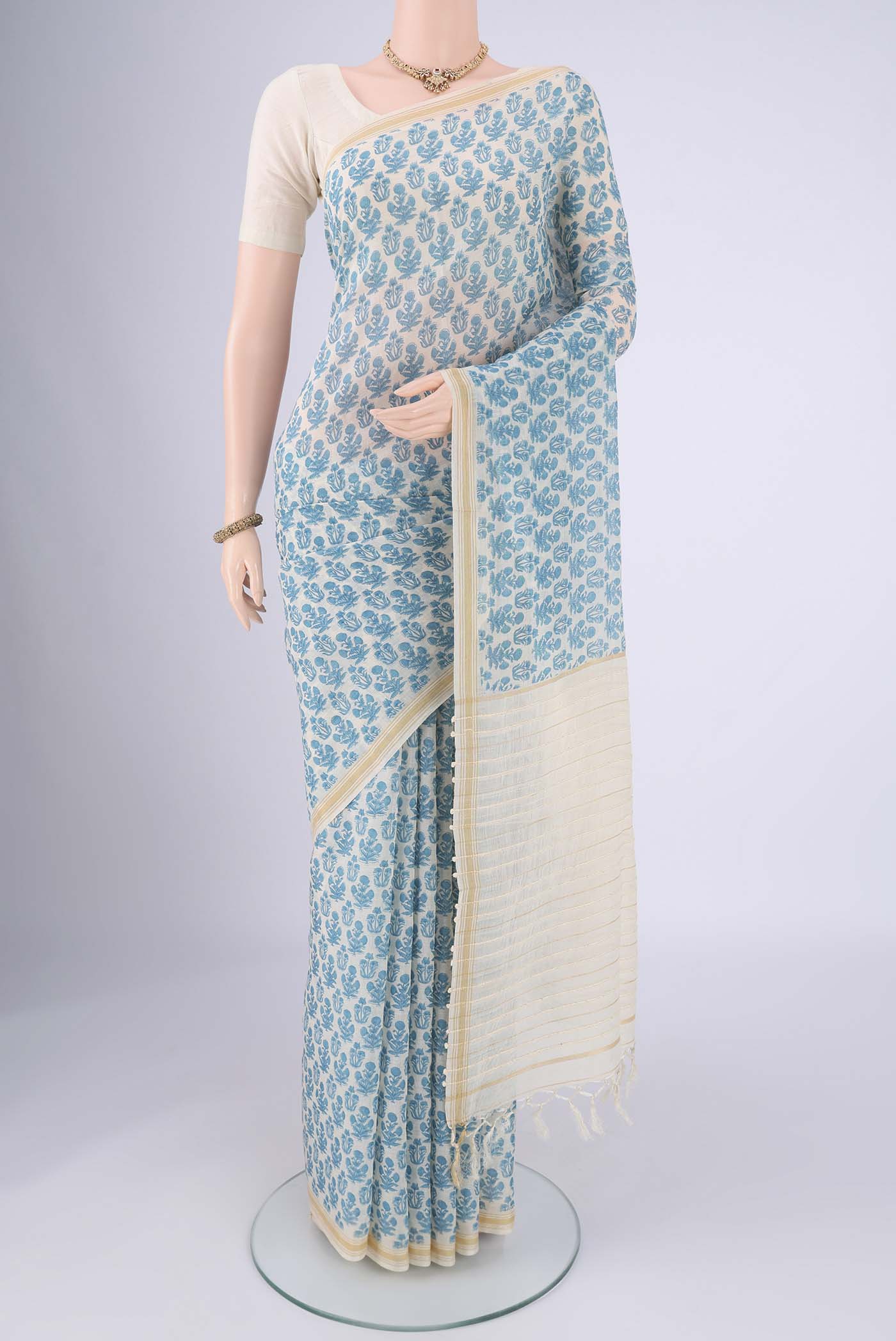 Off White Tussar Silk Saree with Floral Print on the body and Thread Border.  displayed on a mannequin