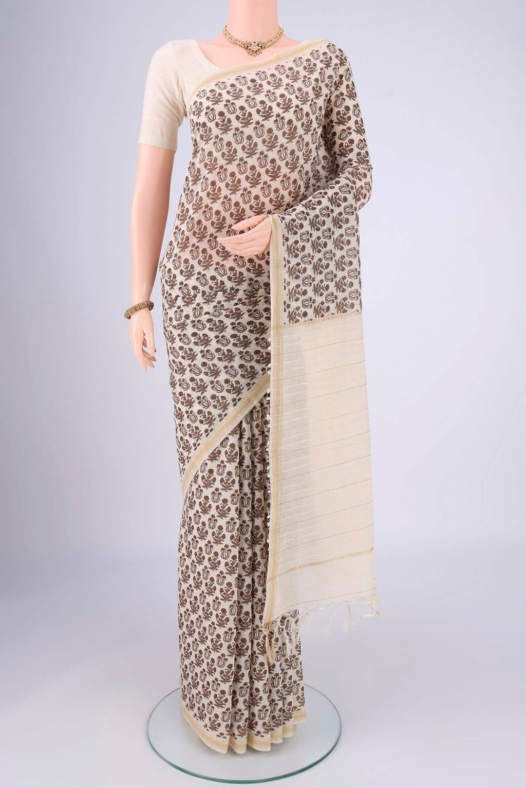 Off White Tussar Silk Saree with Floral Print on the body and Thread Border.  displayed on a mannequin