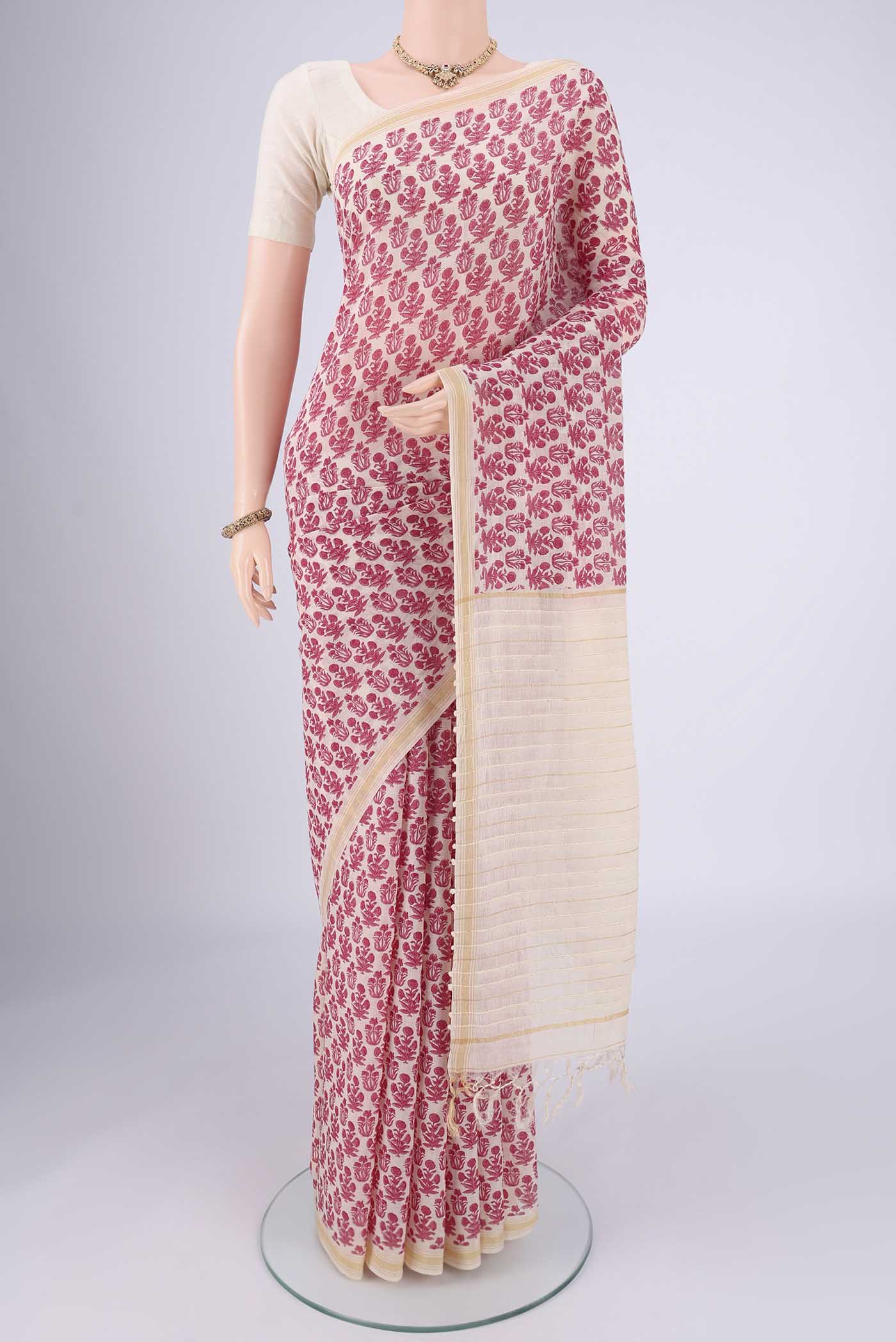 Off White Tussar Silk Saree with Floral Print on the body and Thread Border.  displayed on a mannequin