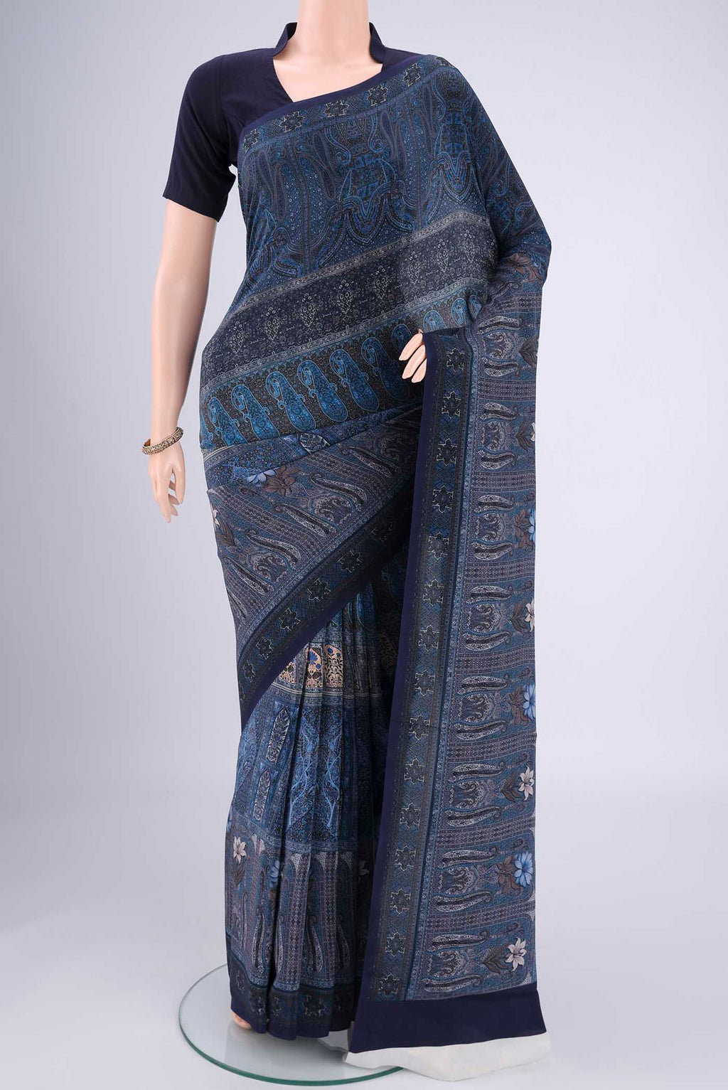 Navy Blue Mysore Crepe Saree with Floral Print on the body and Zari Border.  displayed on a mannequin