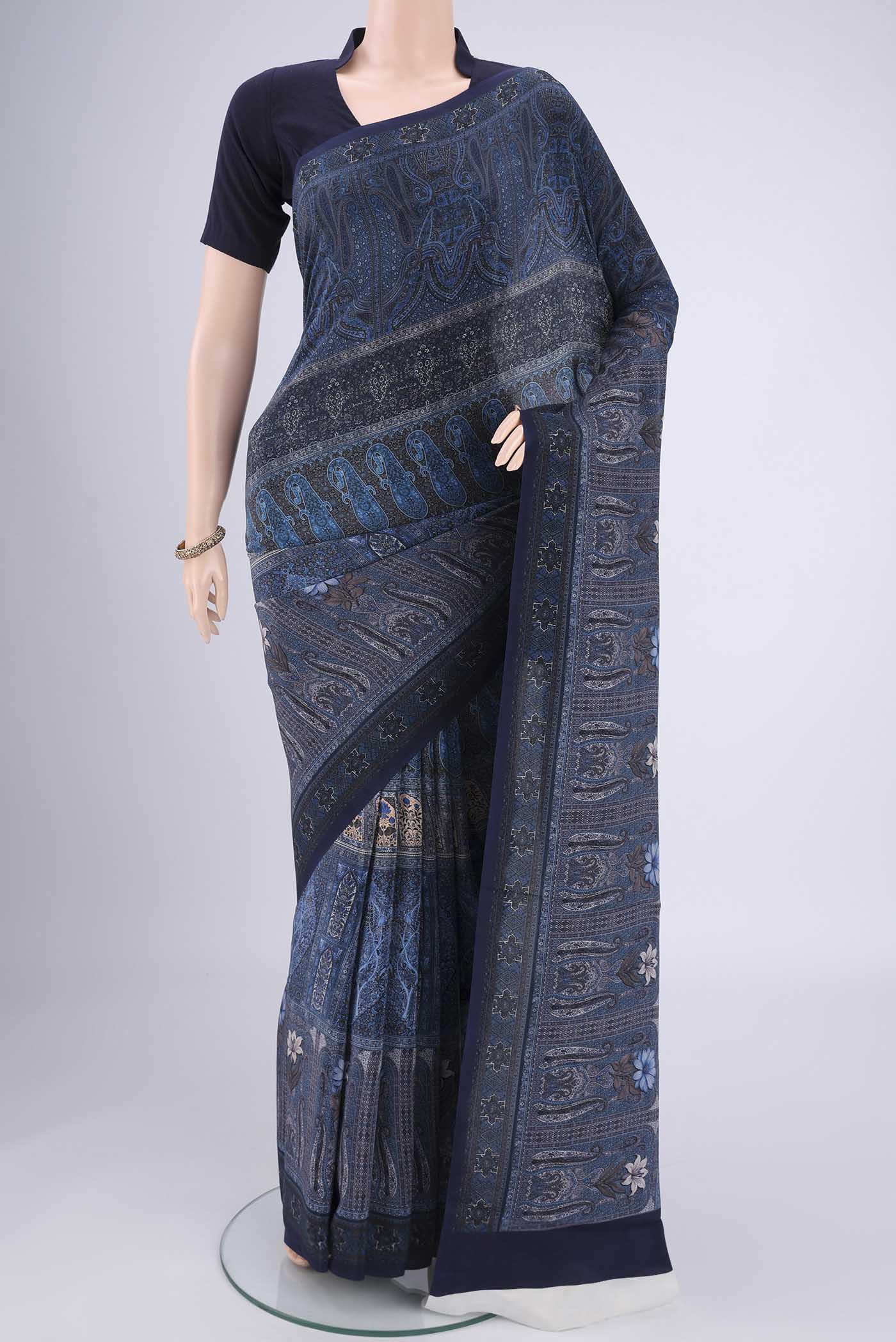 Navy Blue Mysore Crepe Saree with Floral Print on the body and Zari Border.  displayed on a mannequin
