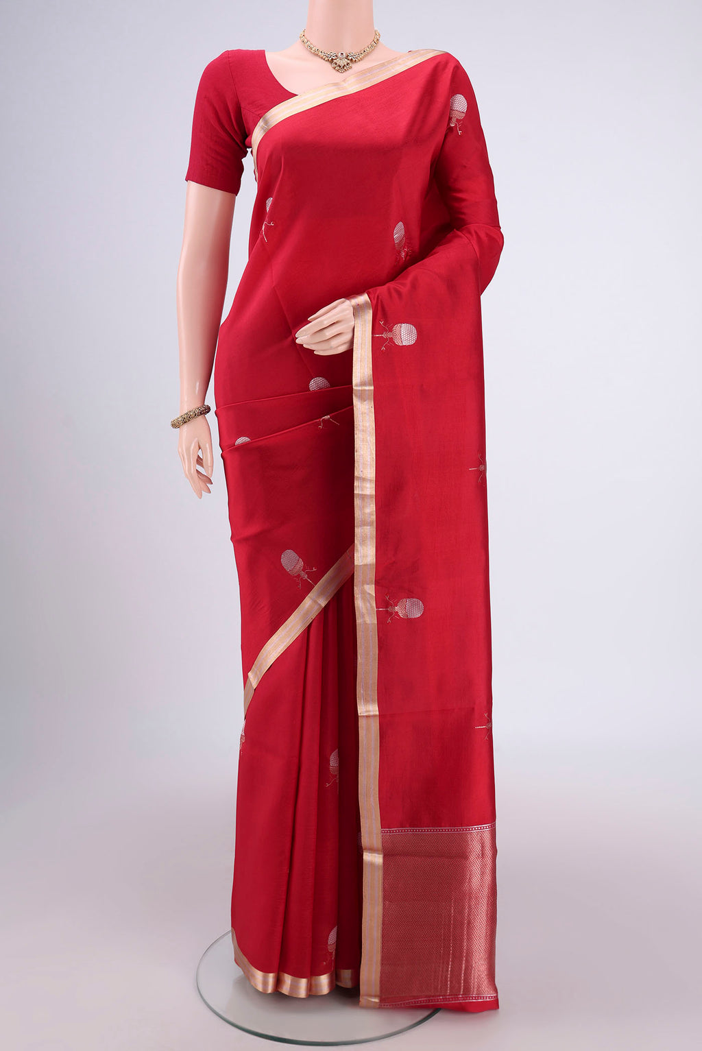Deep Red Banarasi Katan Silk Saree with Zari Butta on the body and Zari Border.  displayed on a mannequin