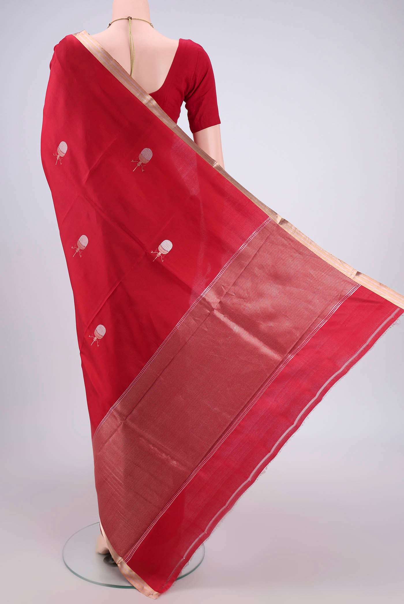 Flat view of Deep Red Banarasi Katan Silk Saree with Zari Butta on the body and Zari Border. 