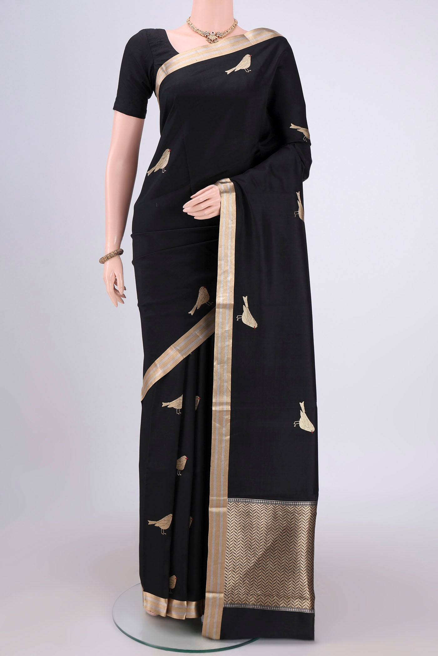 Black Banarasi Katan Silk Saree with Zari Butta on the body and Zari Border.  displayed on a mannequin