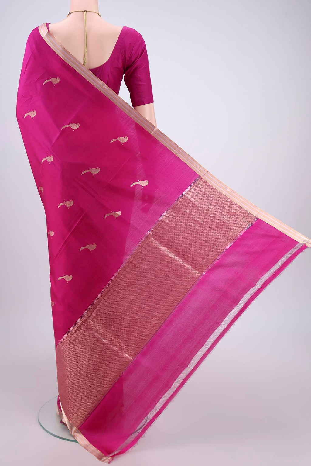 Flat view of Rani Pink Banarasi Katan Silk Saree with Zari And Thread Butta on the body and Zari Border. 