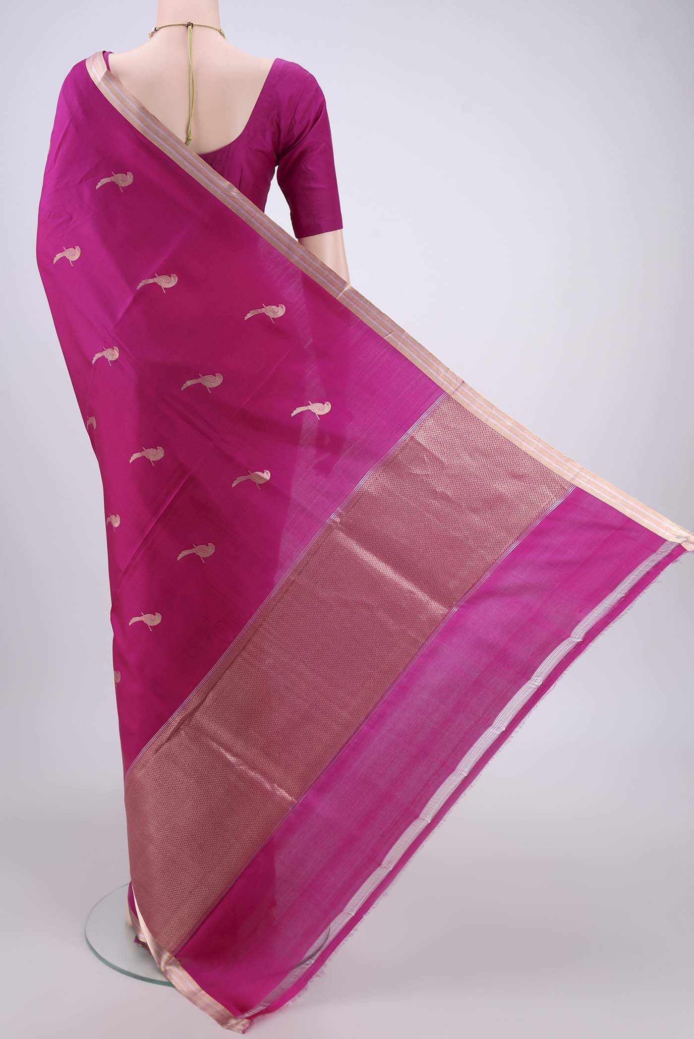 Flat view of Rani Pink Banarasi Katan Silk Saree with Zari And Thread Butta on the body and Zari Border. 