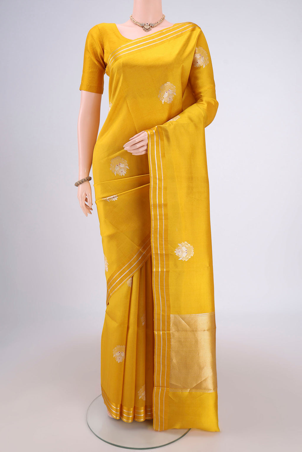 Lemon Yellow Banarasi Katan Silk Saree with Zari Butta on the body and Zari Border.  displayed on a mannequin