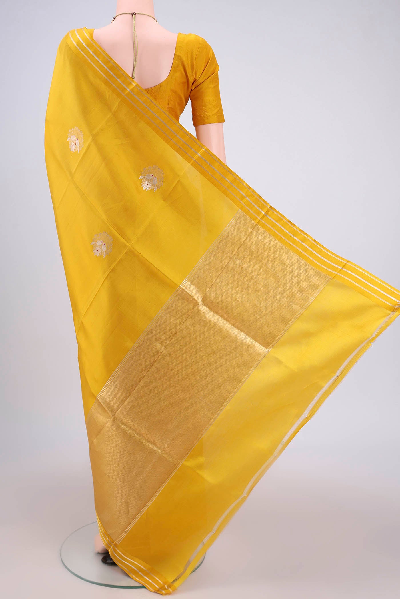 Flat view of Lemon Yellow Banarasi Katan Silk Saree with Zari Butta on the body and Zari Border. 