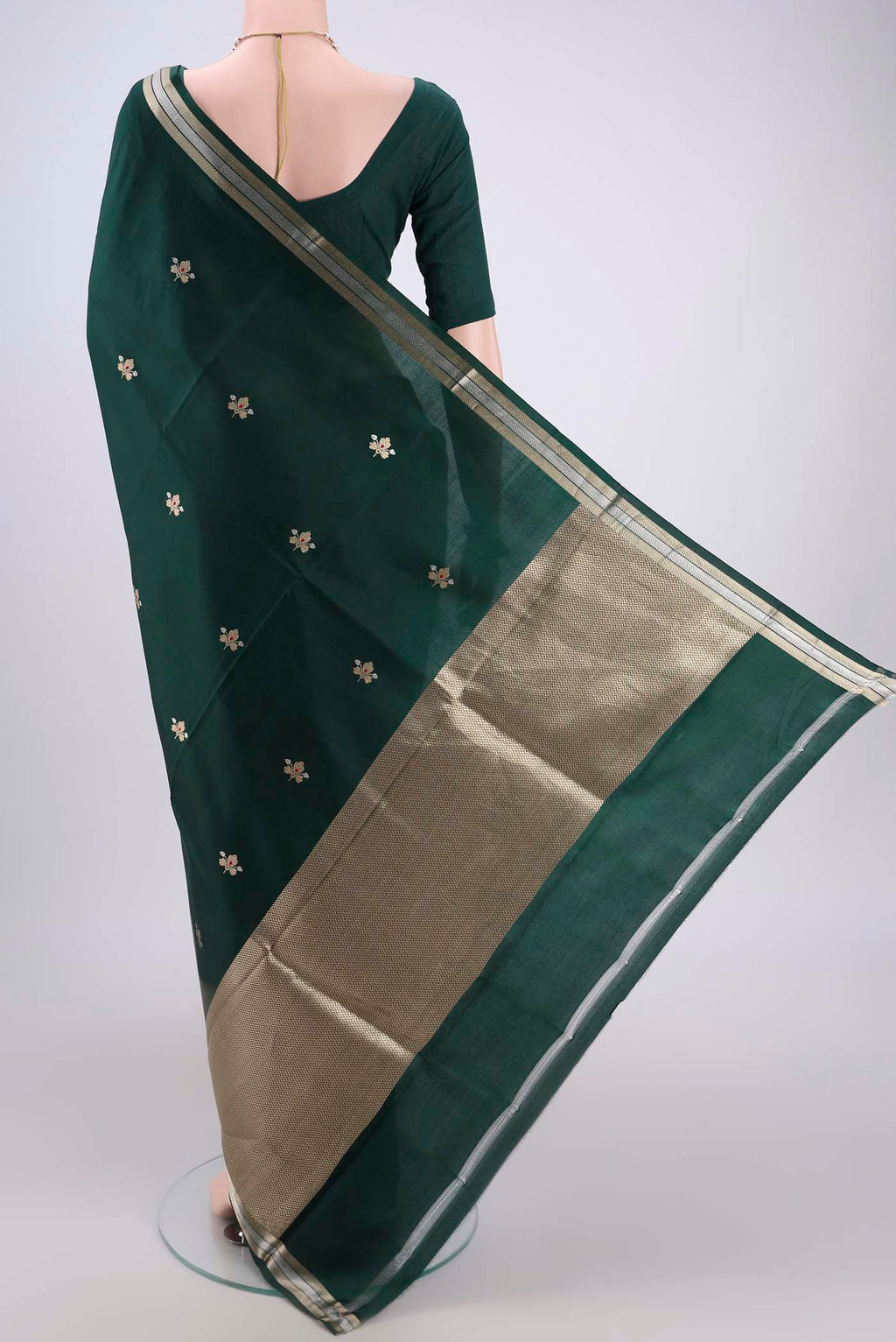 Flat view of Bottle Green Banarasi Katan Silk Saree with Zari Butta on the body and Zari Border. 