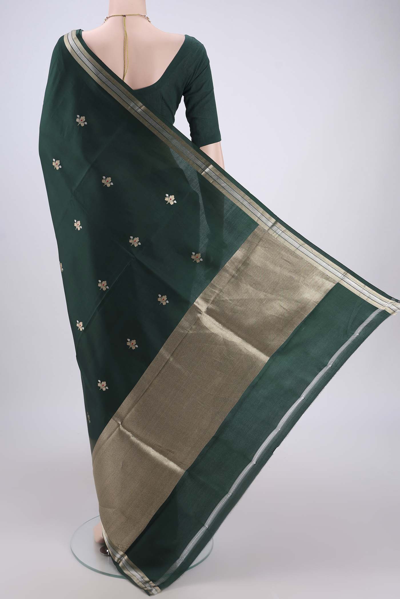 Flat view of Bottle Green Banarasi Katan Silk Saree with Zari Butta on the body and Zari Border. 
