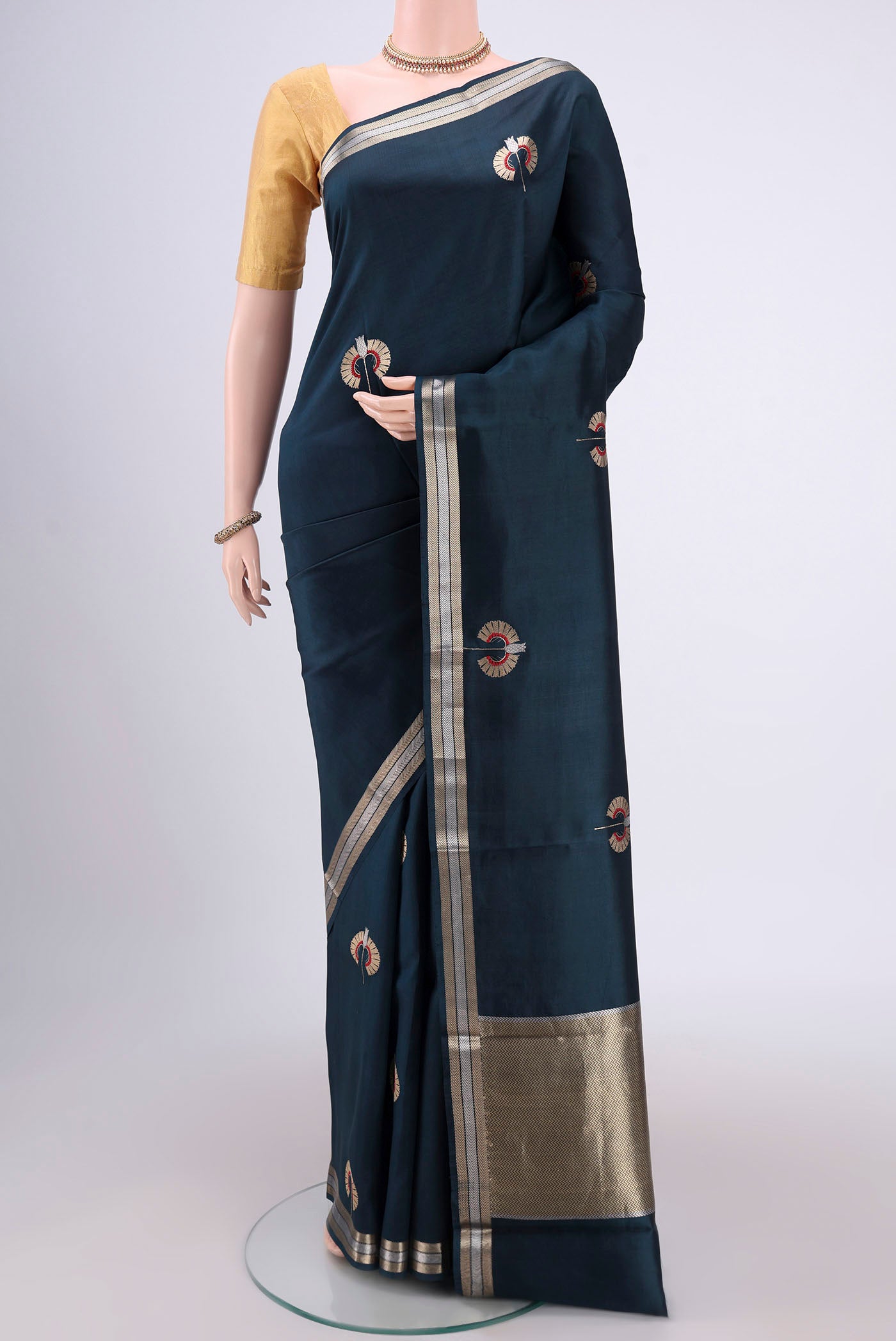 Navy Blue Banarasi Katan Silk Saree with Zari Butta on the body and Zari Border.  displayed on a mannequin