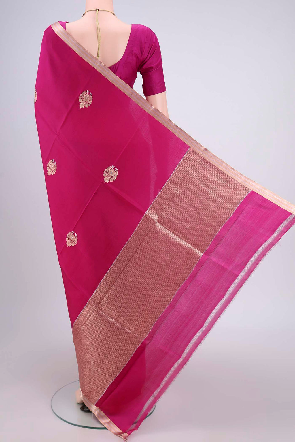 Flat view of Rani Pink Banarasi Katan Silk Saree with Zari Butta on the body and Zari Border. 